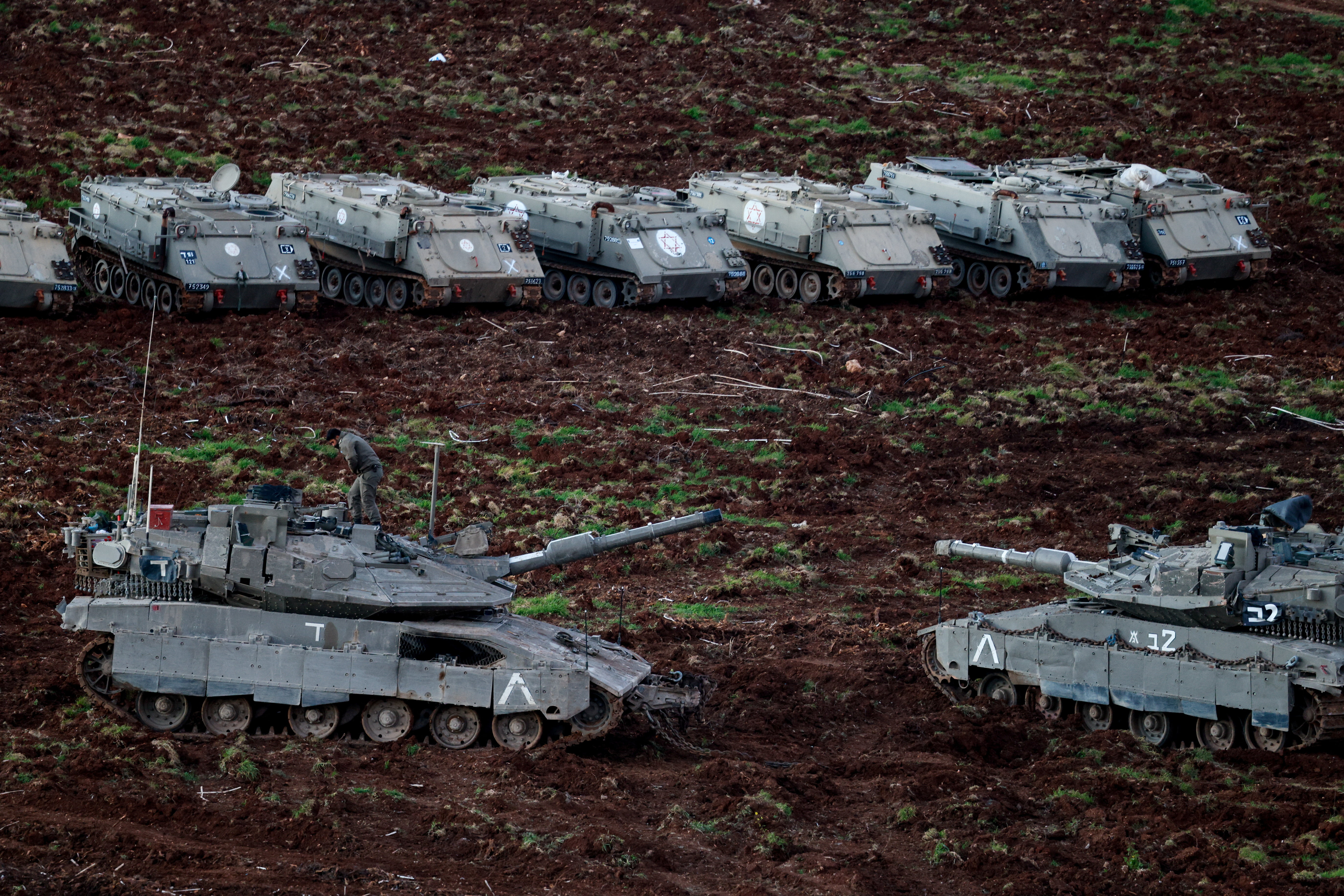 Israeli tanks and APCs (armoured personnel carriers) on the Israeli side of the Israel-Lebanon border, following an escalation between Hezbollah and Israel