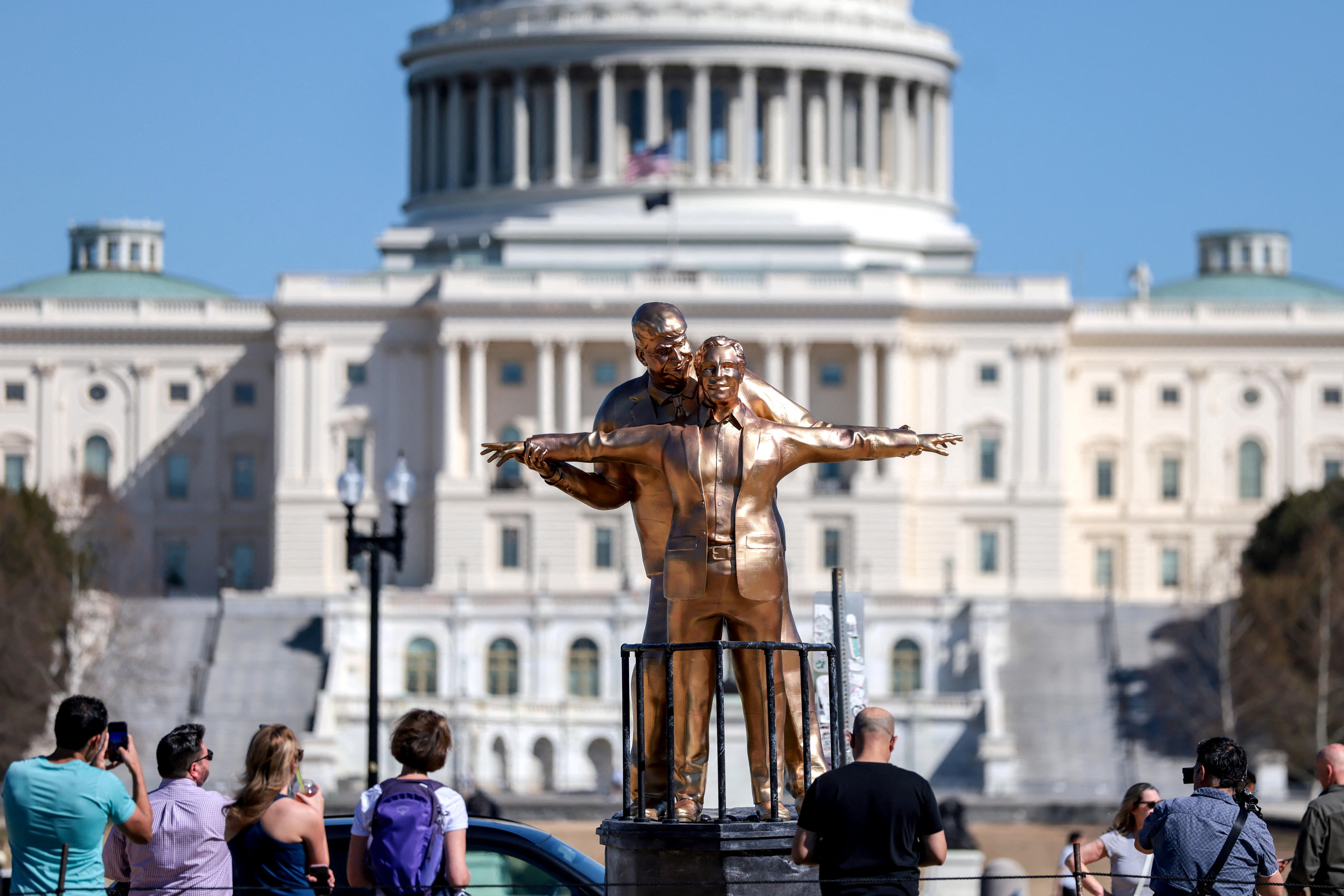 People look at a statue depicting U.S. President Donald Trump and convicted sex offender Jeffrey Epstein, entitled “The King of the World”, on the National Mall in Washington, D.C., U.S., March 10, 2026. REUTERS/Evelyn Hockstein