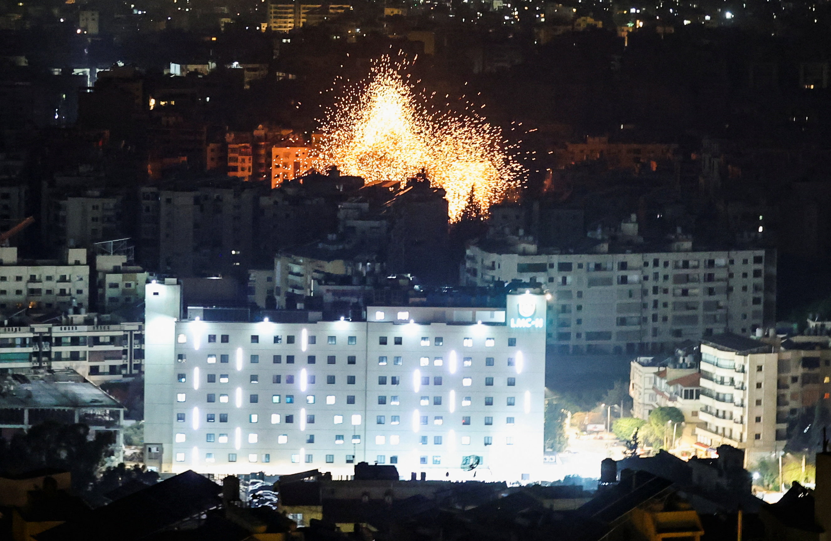 A burst of burning debris erupts following reported Israeli strikes in the southern suburbs of Beirut, after an escalation between Hezbollah and Israel, amid the U.S.-Israeli conflict with Iran, Lebanon, March 13, 2026.