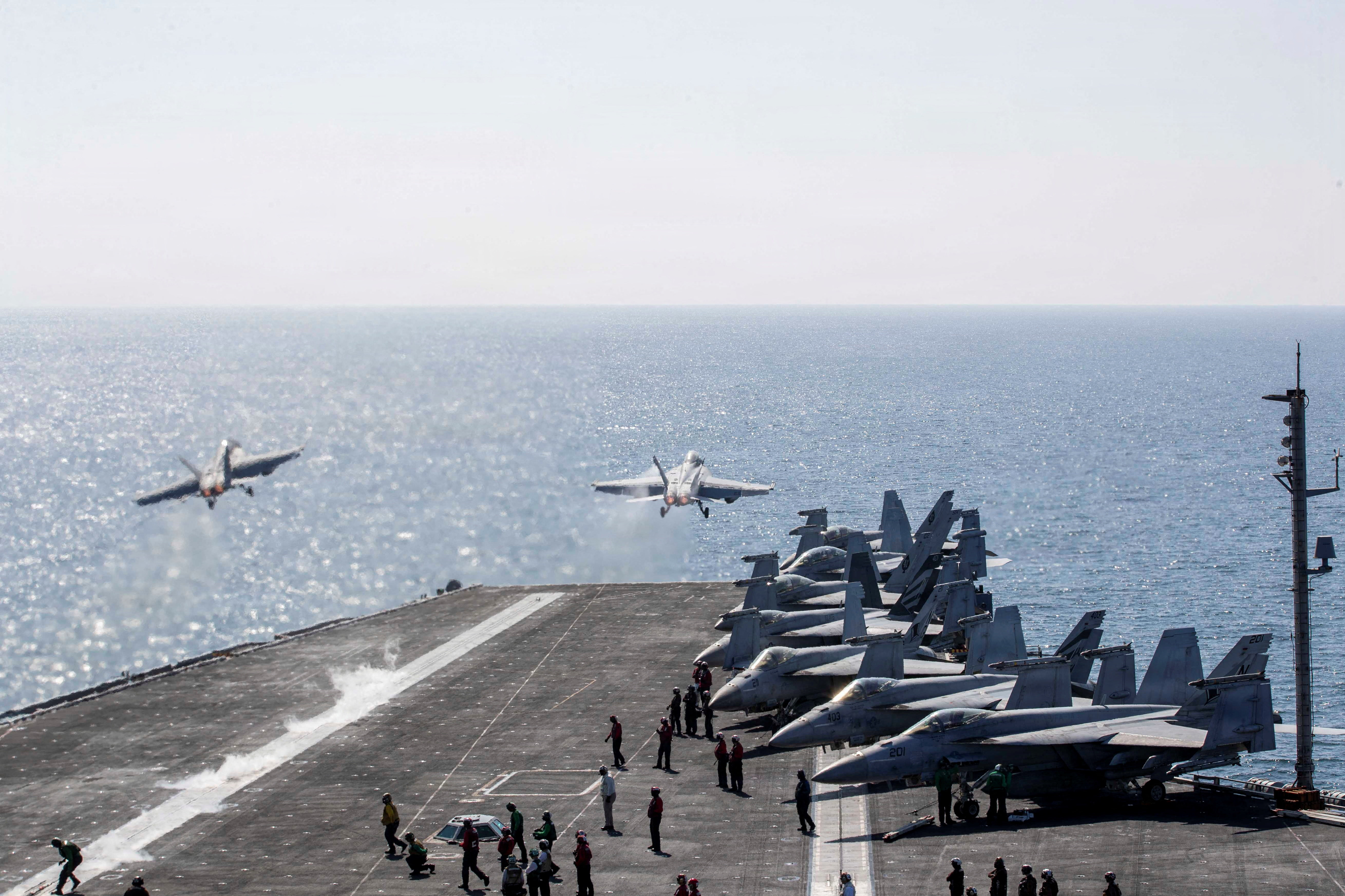 Two F/A-18 Super Hornets launch from the flight deck of the U.S. Navy Nimitz-class aircraft carrier USS Abraham Lincoln in support of the Operation Epic Fury attack on Iran from an undisclosed location March 3, 2026.