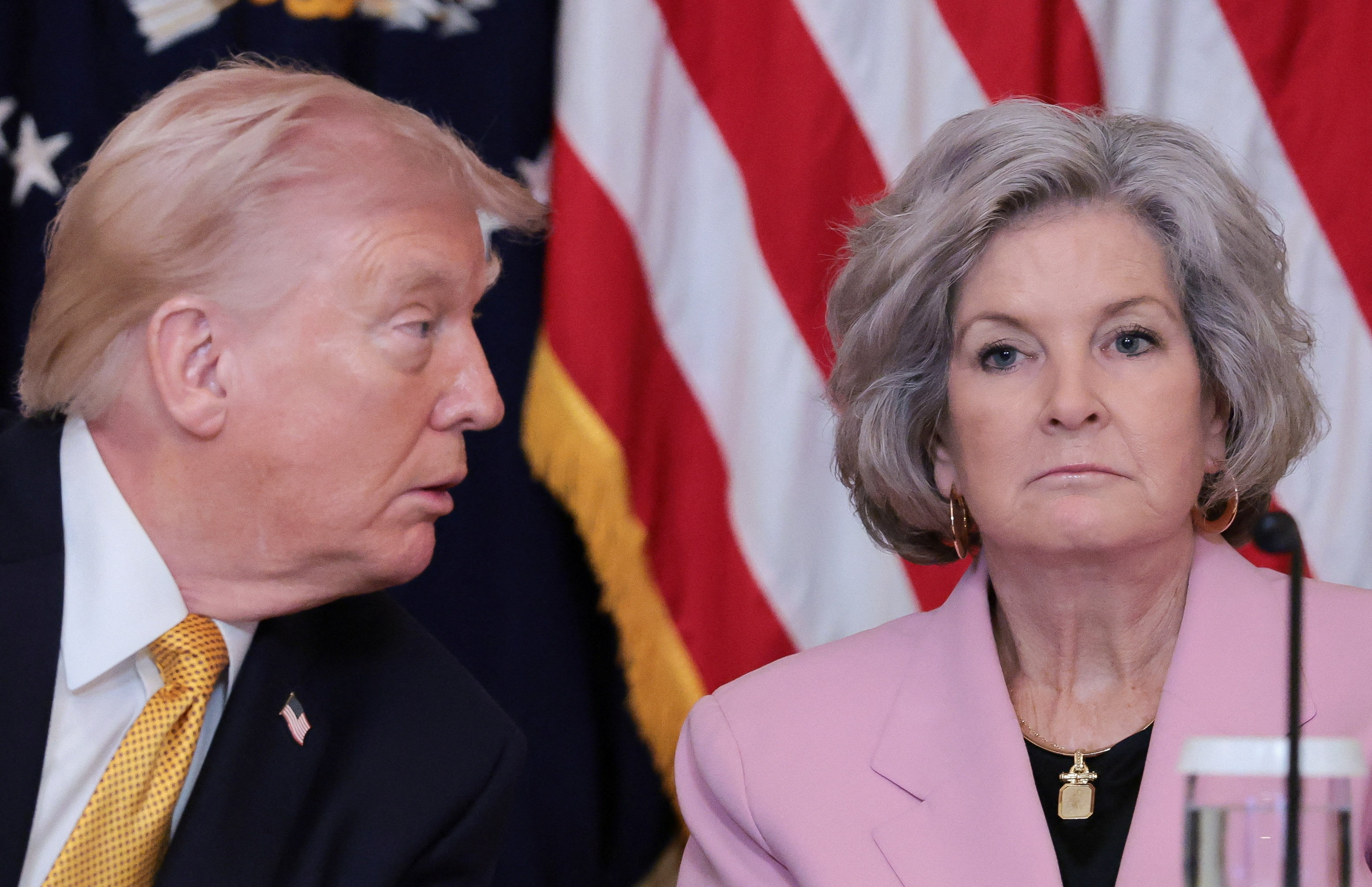 U.S. President Donald Trump approaches White House chief of staff Susie Wiles during a lunch with the Kennedy Center board members in the East Room of the White House in Washington, D.C.