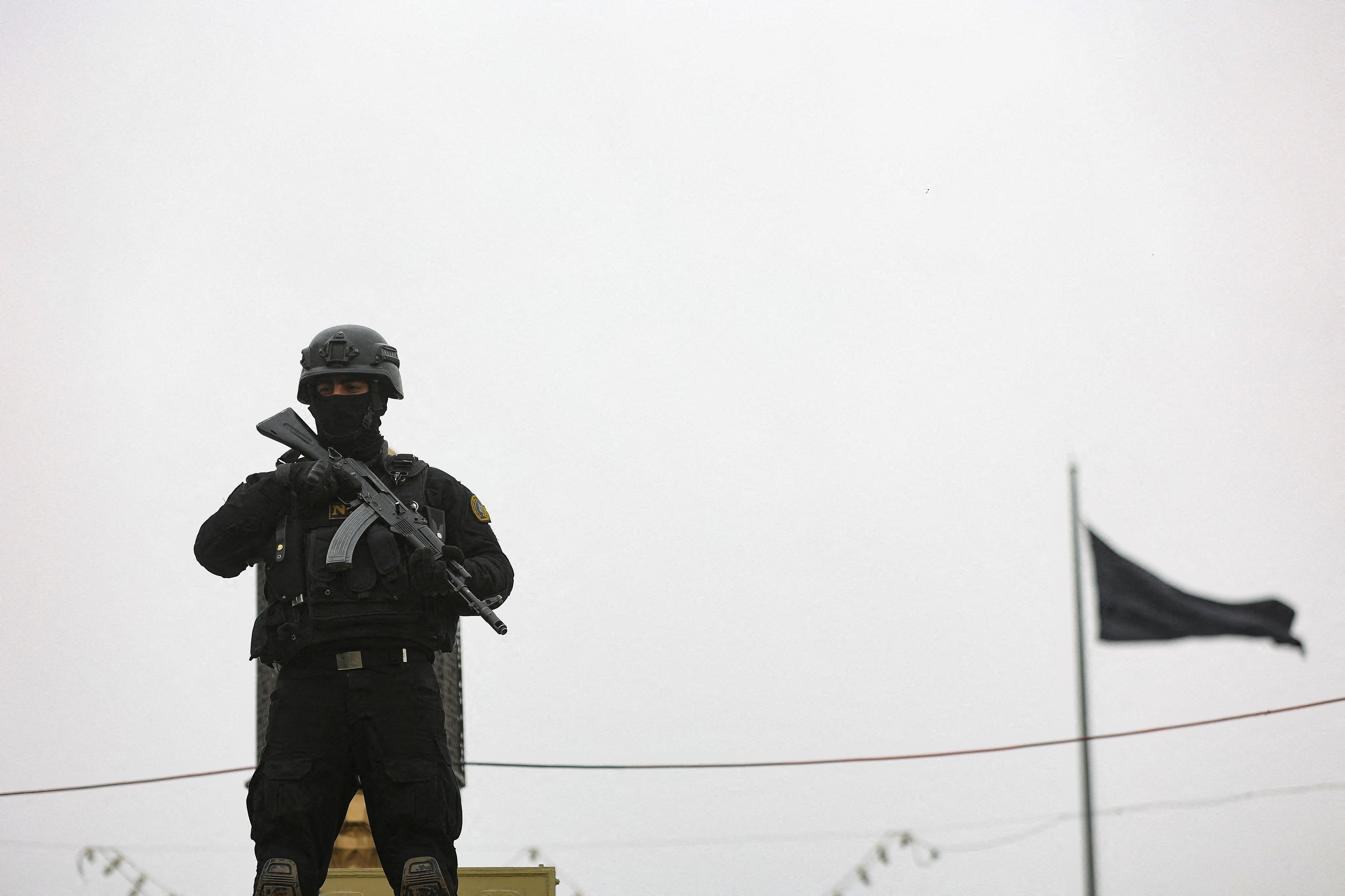 A security personnel stands guard as Iranians take part in a protest marking the annual al-Quds Day (Jerusalem Day) on the last Friday of the holy month of Ramadan, amid the U.S.-Israeli conflict with Iran, in Tehran, Iran, March 13, 2026.