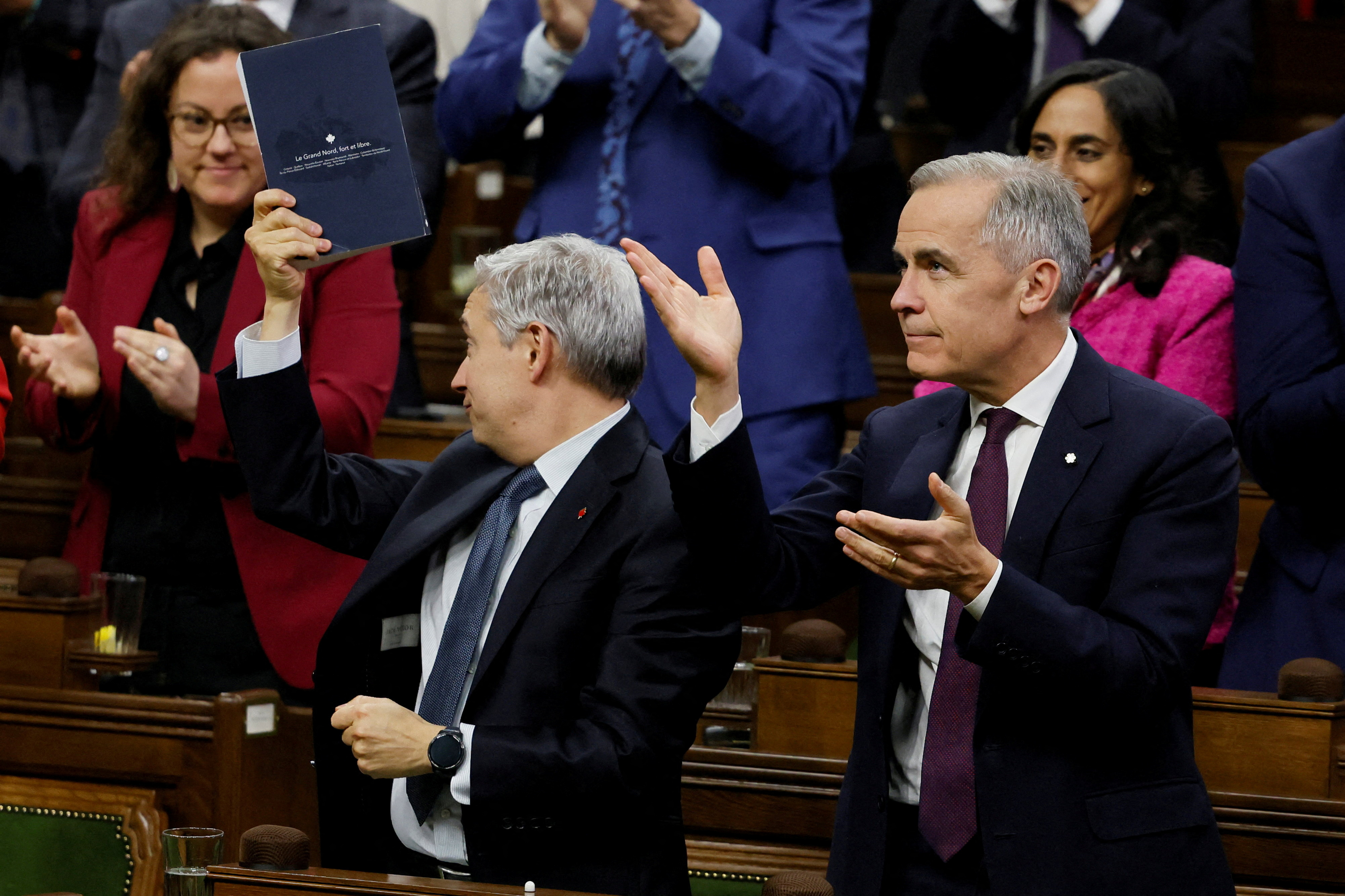 FILE PHOTO: Canada's Prime Minister Mark Carney and Minister of Finance Francois-Philippe Champagne celebrate after a confidence vote on the federal budget passes