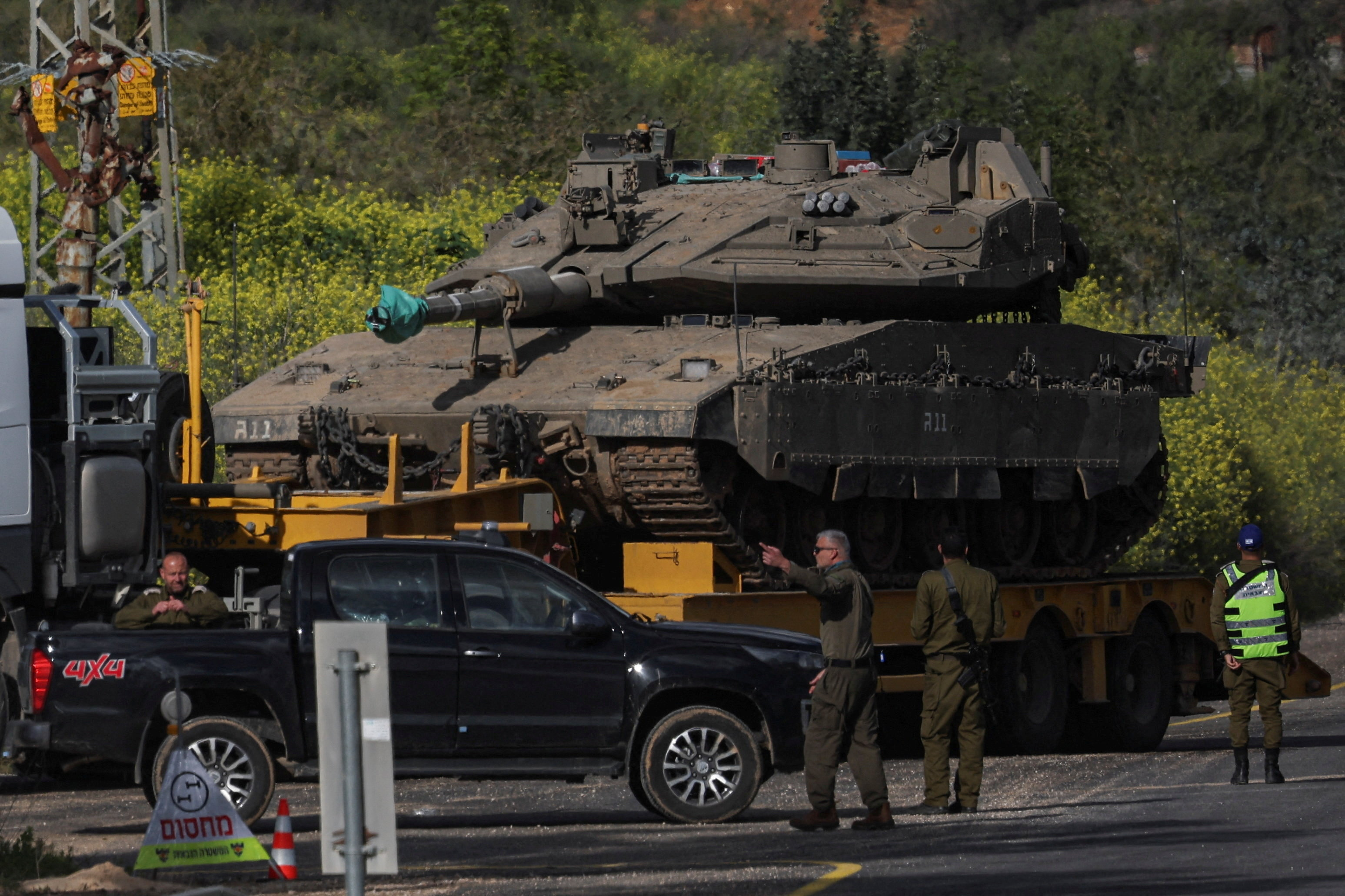 An Israeli tank is transported on the Israeli side of the border with Lebanon, amid escalation between Iran-backed Hezbollah and Israel and the U.S.-Israeli conflict with Iran, in northern Israel