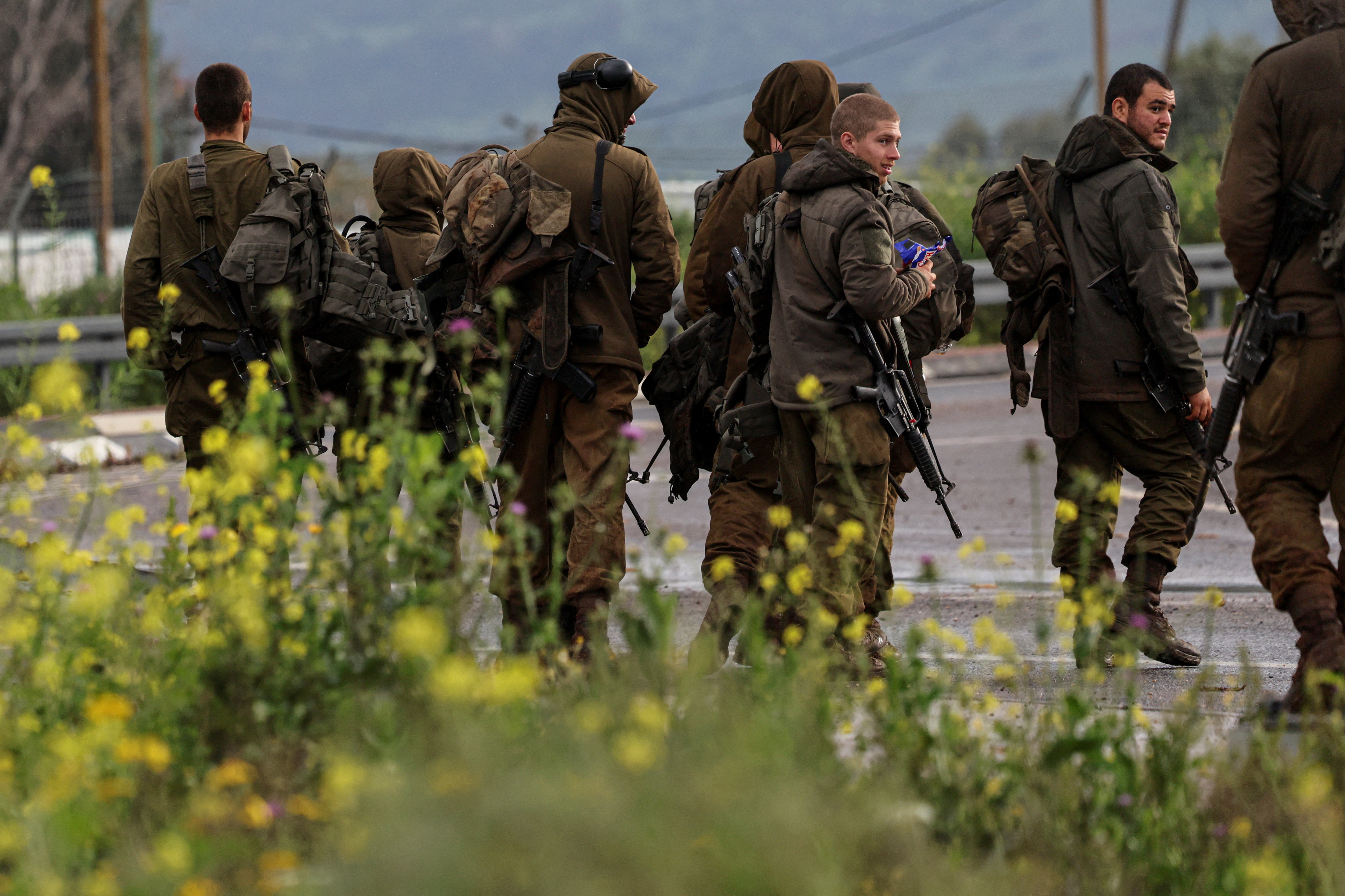 Israeli soldiers arrive at a base near the Israeli side of the border with Lebanon, amid escalation between Iran-backed Hezbollah and Israel and the U.S.-Israeli conflict with Iran, in northern Israel