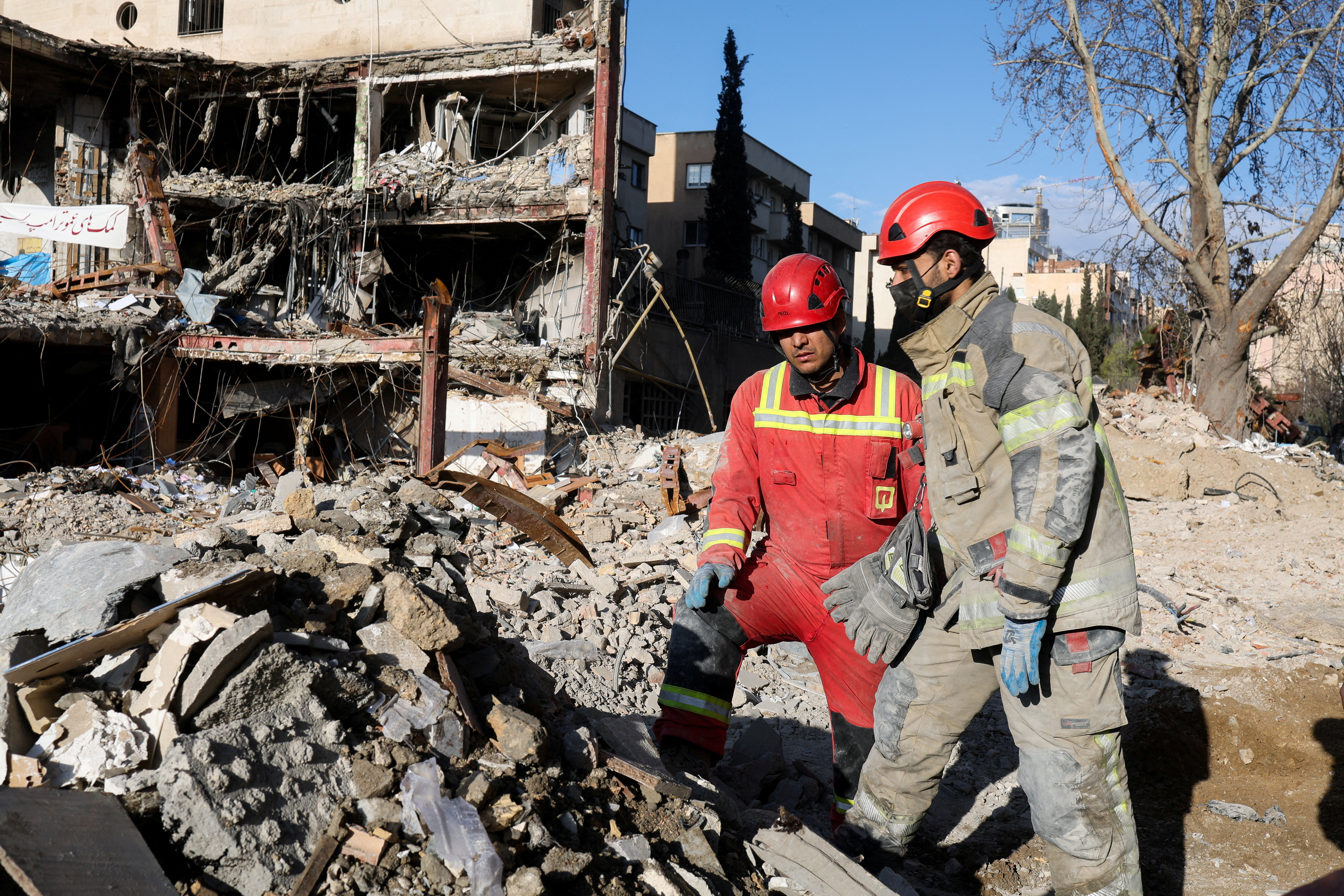 Members of a Red Crescent rescue team work at a building that was damaged by a strike, amid the U.S.-Israeli conflict with Iran, in Tehran, Iran, March 21, 2026.