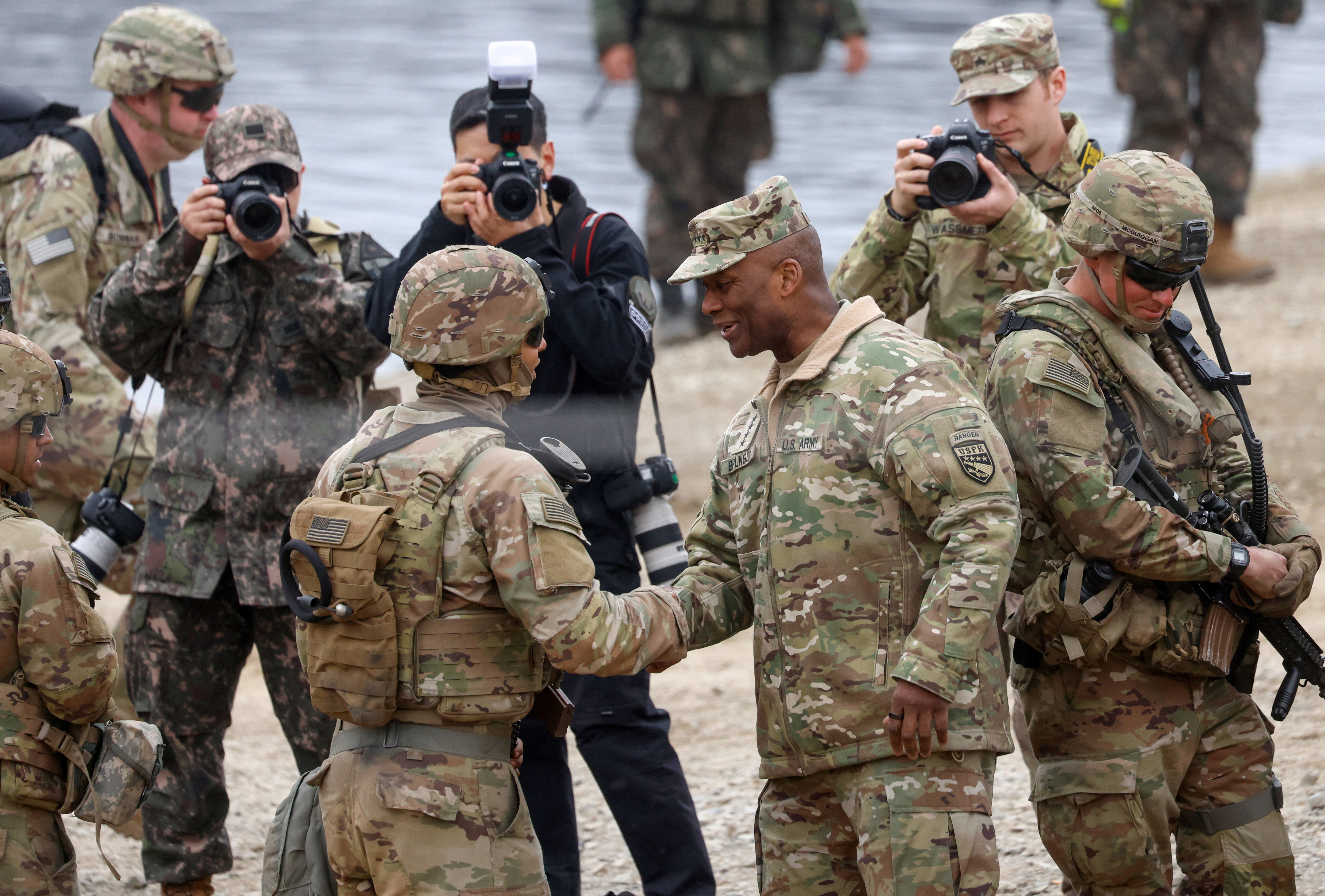 U.S. General Xavier T. Brunson, commander of the ROK/US Combined Forces Command (CFC), the United States Forces Korea (USFK) and the United Nations Command (UNC), shakes hands with a U.S. Army soldier