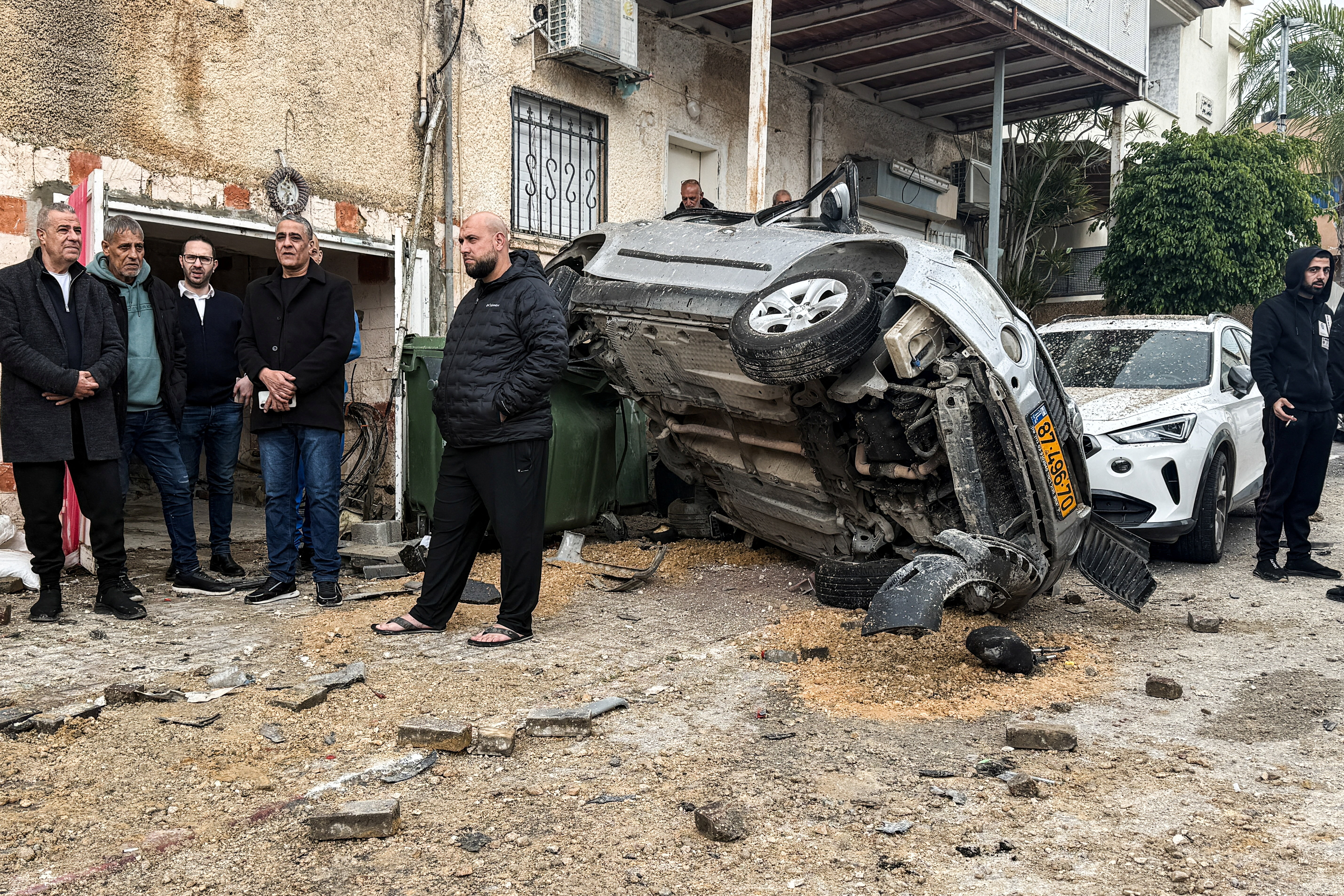 People gather at the missile impact site, after Iranian missile barrages were launched at Israel, amid the U.S.-Israel conflict with Iran, in central Israel, March 26, 2026.