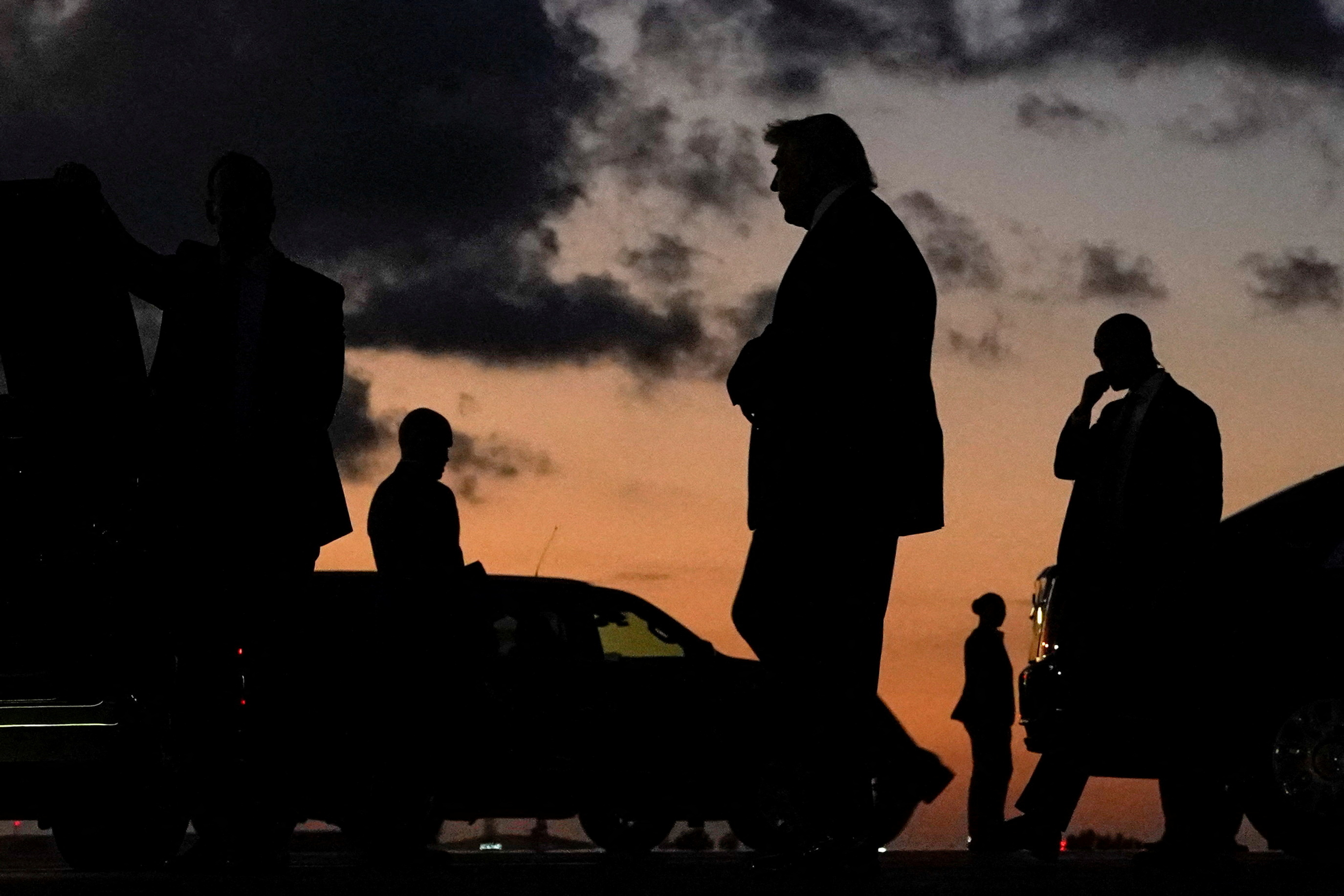 FILE PHOTO: U.S. President Donald Trump is silhouetted as he walks upon arrival at Palm Beach International Airport in West Palm Beach, Florida, U.S., March 27, 2026. REUTERS/Elizabeth Frantz/File Photo