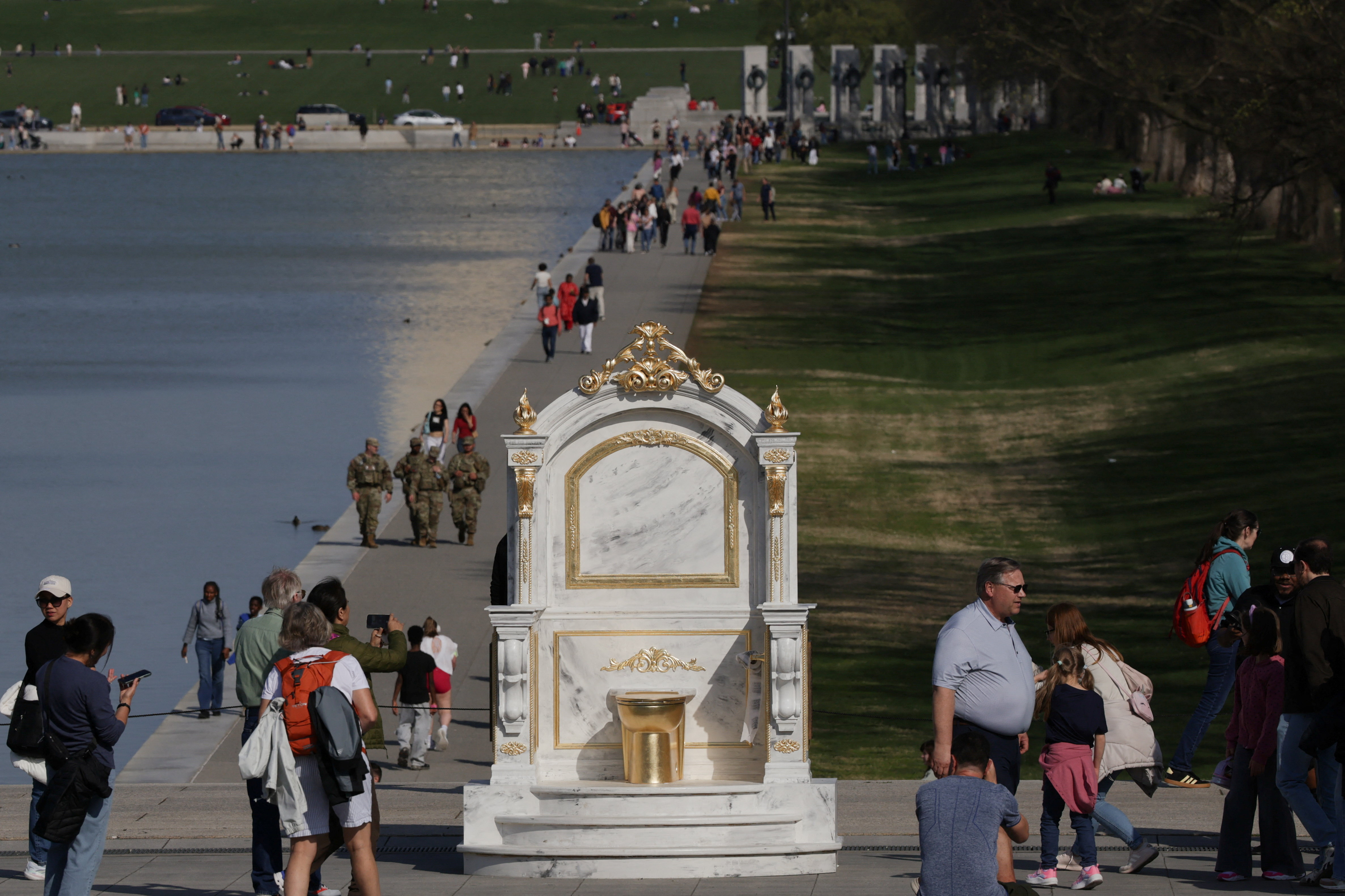 A statue featuring a large golden toilet, titled "A Throne Fit for a King," is displayed near the Lincoln Memorial on the National Mall in Washington, D.C., U.S., March 30, 2026. REUTERS/Evelyn Hockstein