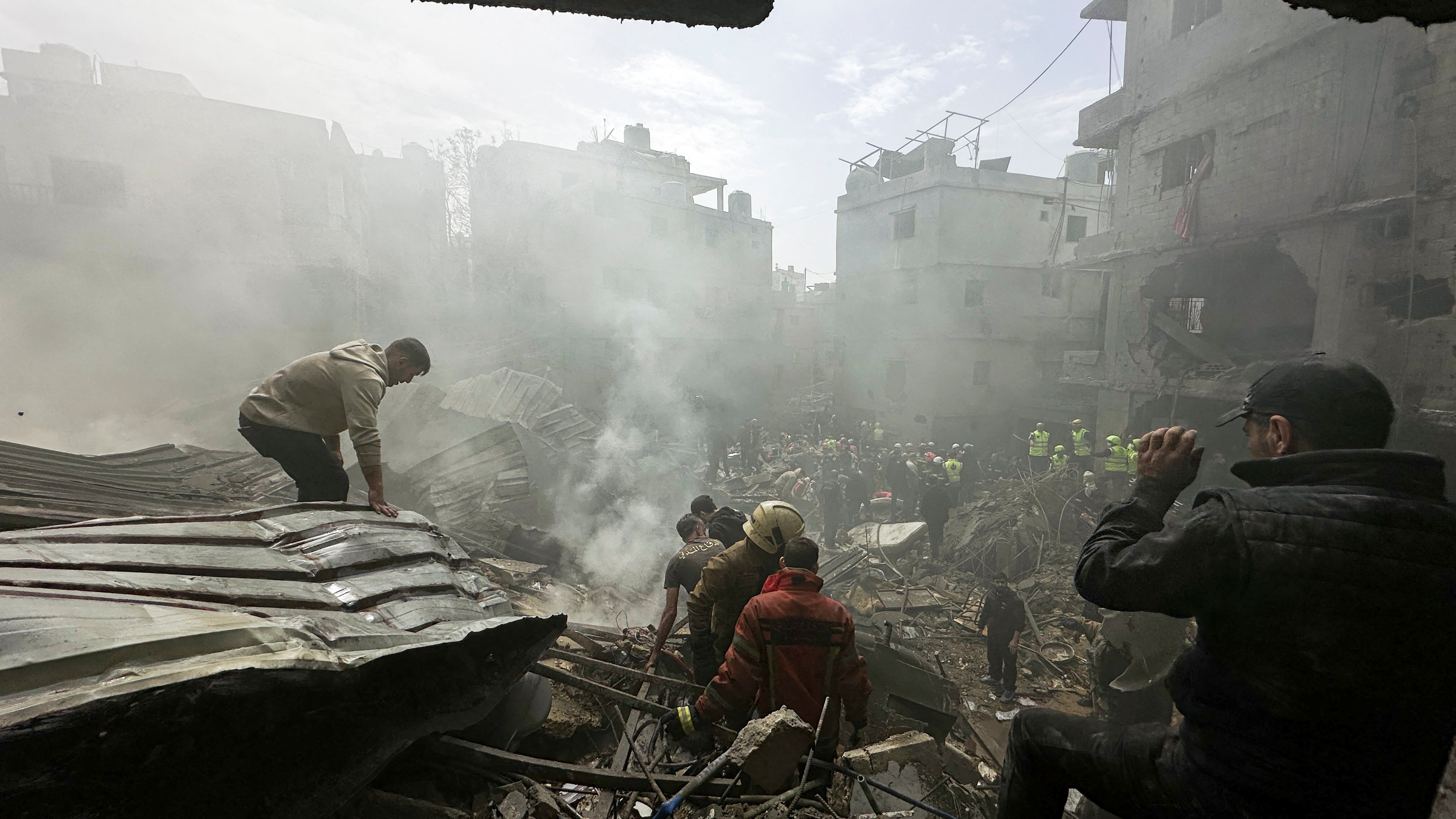 People gather as rescuers work at the site of an Israeli strike, amid escalating hostilities between Israel and Hezbollah, as the U.S.-Israel conflict with Iran continues, in the Jnah area in Beirut, Lebanon, April 5, 2026.