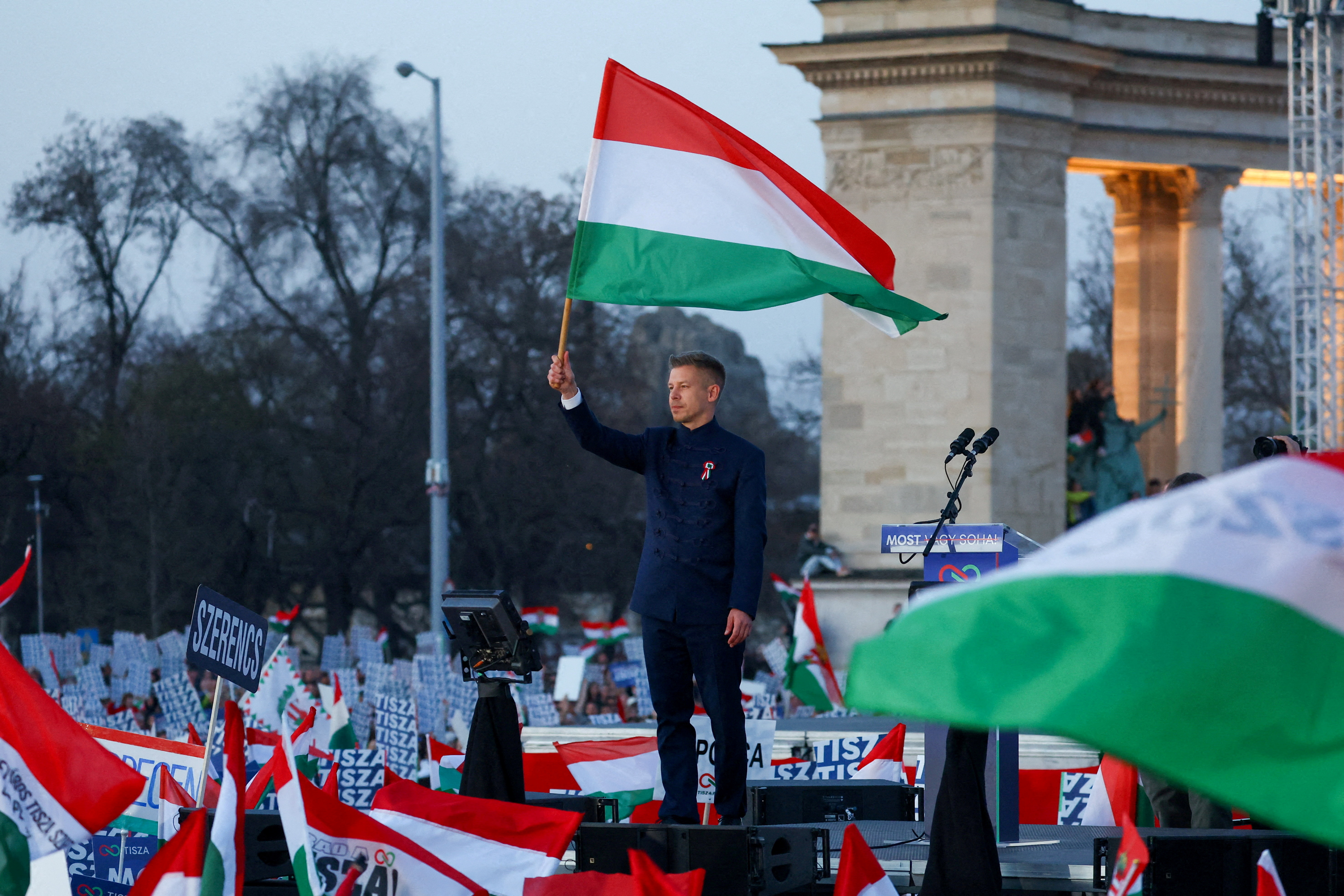 FILE PHOTO: Peter Magyar, leader of the opposition Tisza party, holds a Hungarian flag during Hungary's National Day celebrations, which also commemorates the 1848 Hungarian Revolution against Habsburg rule, in Budapest, Hungary, March 15, 2026.