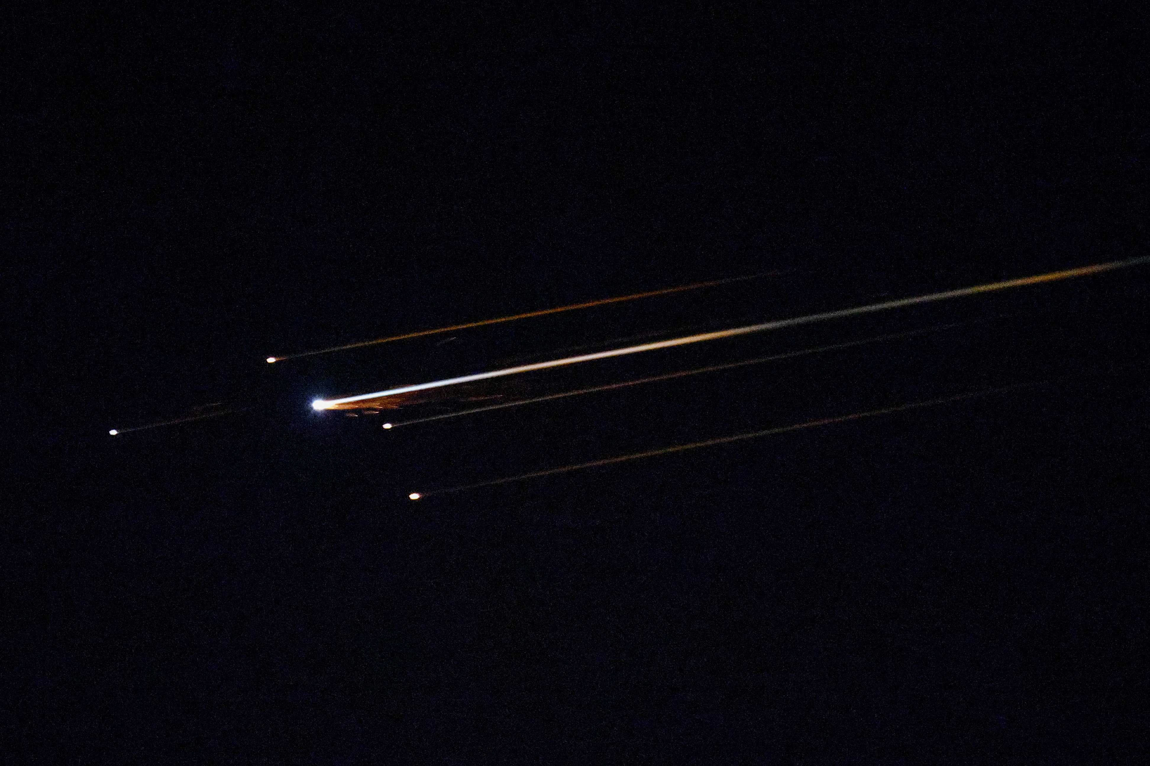 Streaks of light illuminate the sky during an interception attempt, amid the U.S.-Israeli conflict with Iran, as seen from Ashkelon, Israel, April 4, 2026.