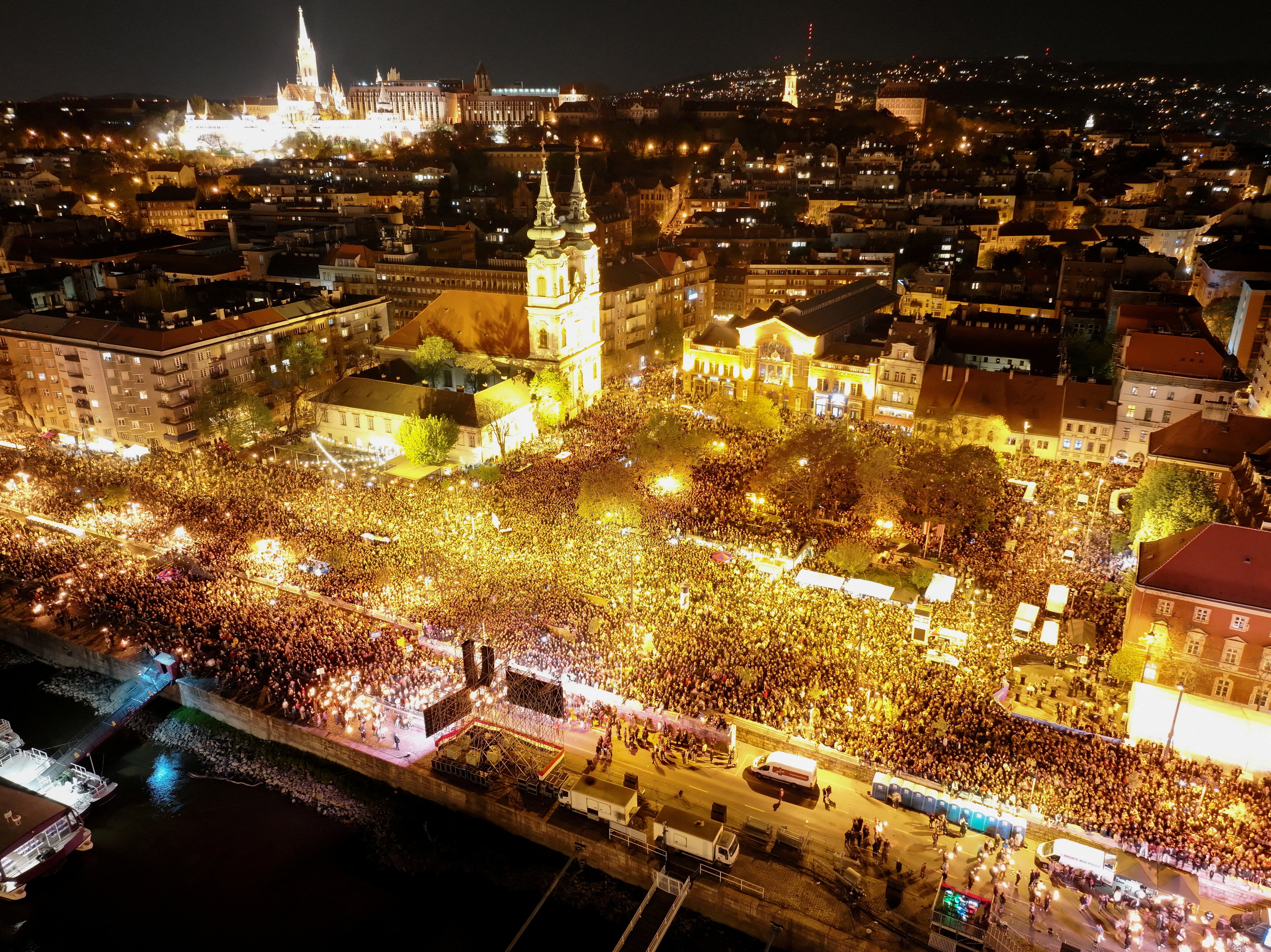 A drone view shows people gathering to celebrate across the River Danube from the Parliament building, following the partial results of the parliamentary election, in Budapest, Hungary, April 12, 2026. REUTERS/Stringer     TPX IMAGES OF THE DAY