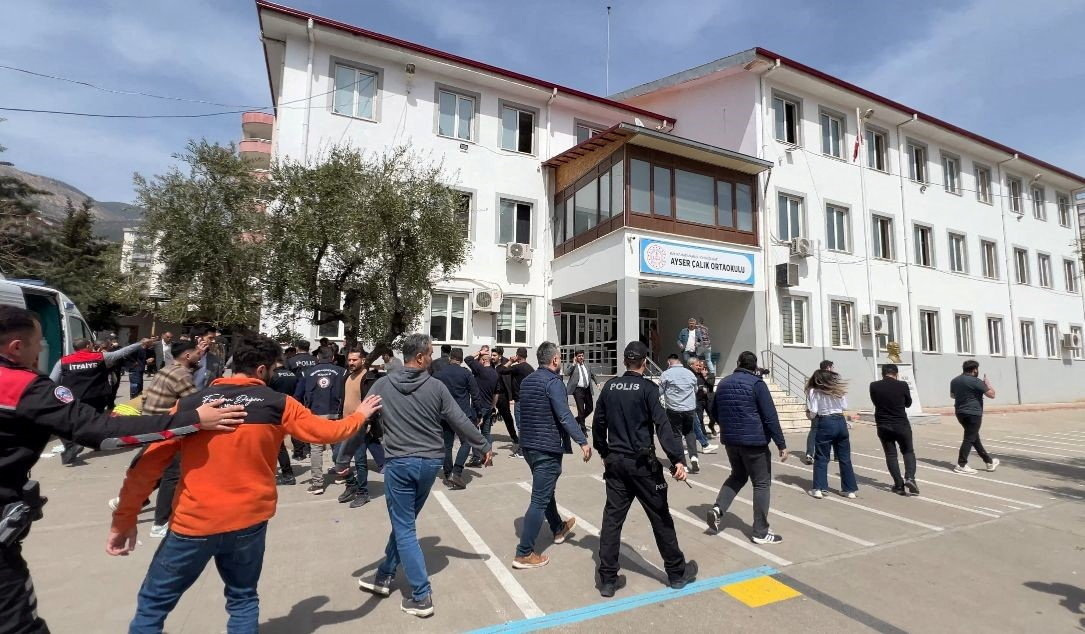 Police officers in uniform and plainclothes police secure the site after a deadly school shooting. IHA (Ihlas News Agency) via REUTERS