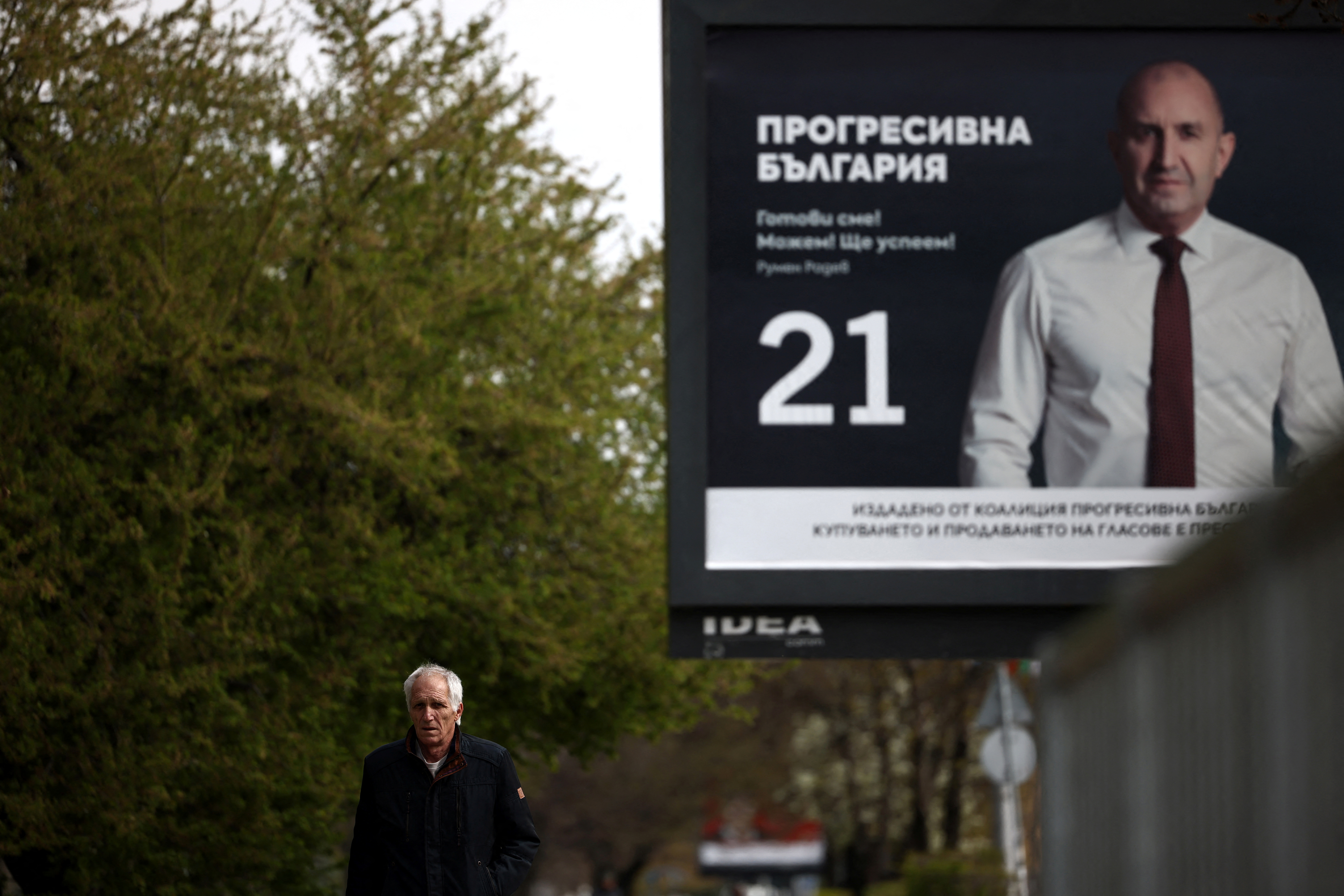 A man walks past an election billboard of the Progressive Bulgaria coalition's leader and former President Rumen Radev, ahead of the snap election, in Sofia, Bulgaria, April 14, 2026. REUTERS/Spasiyana Sergieva