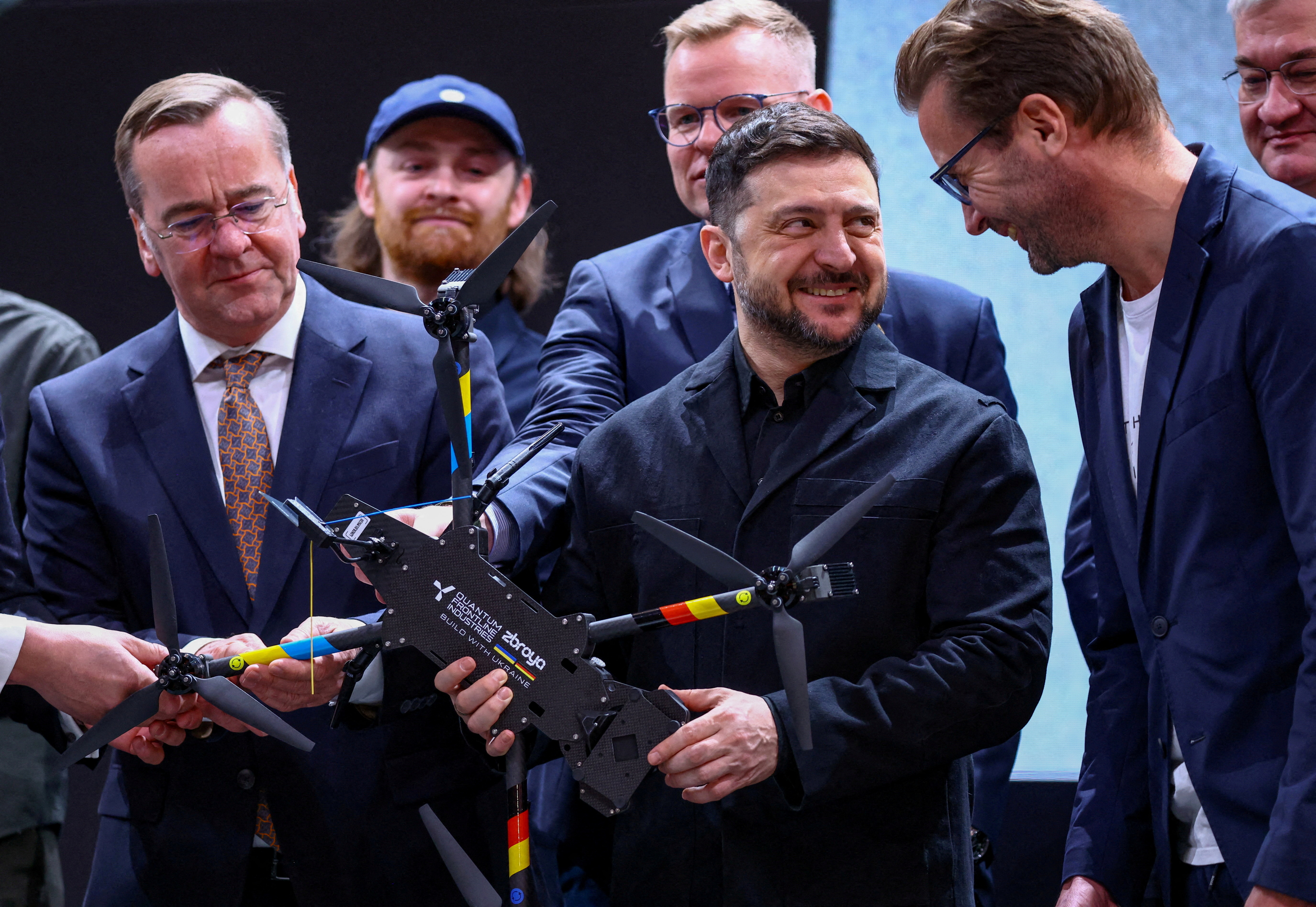 FILE PHOTO: Ukrainian President Volodymyr Zelenskiy holds a drone of German drone maker Quantum Systems, along with Germany's Defence Minister Boris Pistorius, during a visit to the firm on the sidelines of the annual Munich Security Conference (MSC)