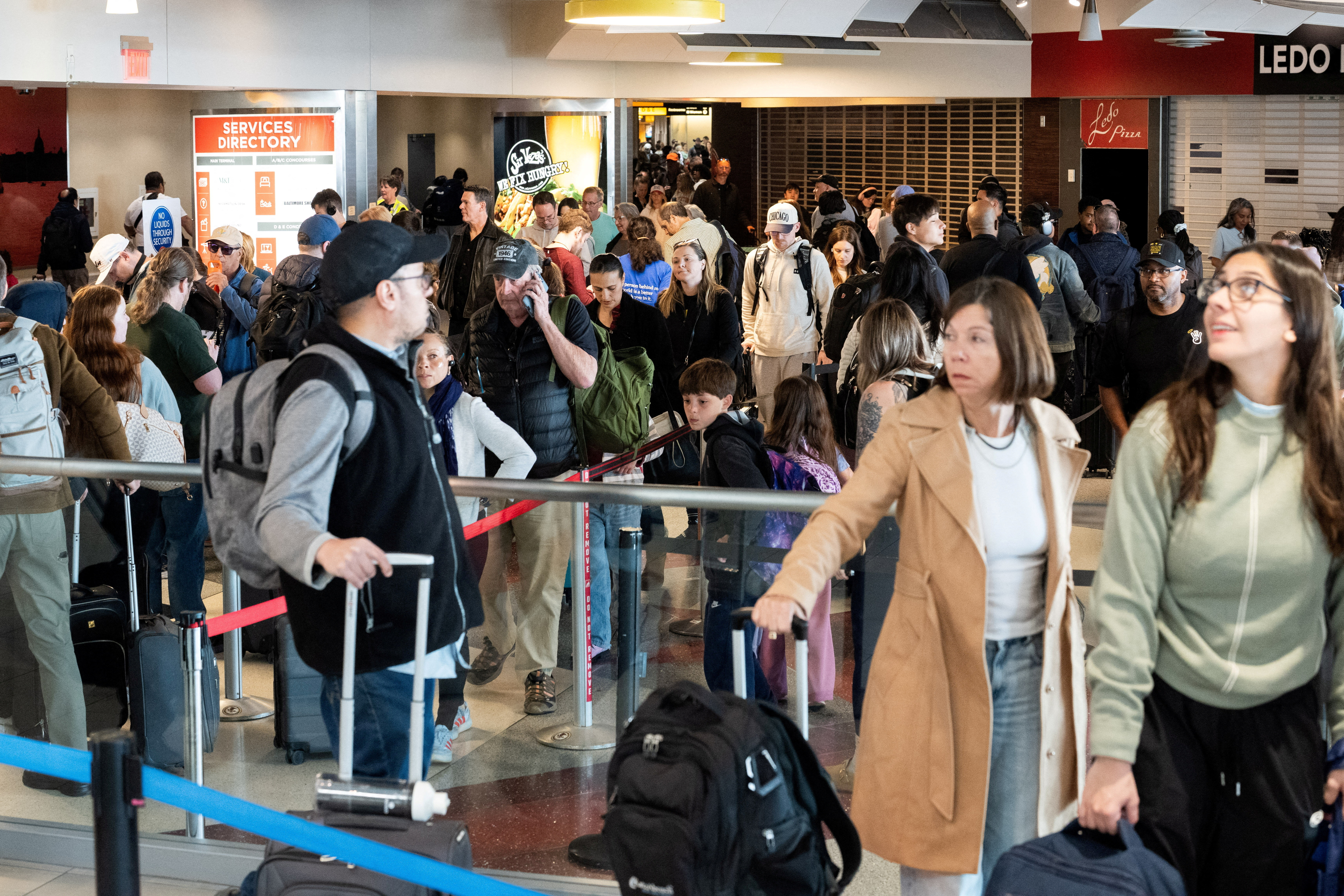 FILE PHOTO: Passengers wait in a TSA security checkpoint queue that stretches through Baltimore/Washington International Thurgood Marshall Airport (BWI) in Baltimore, Maryland., U.S., March 29, 2026. REUTERS/Aaron Schwartz/File Photo