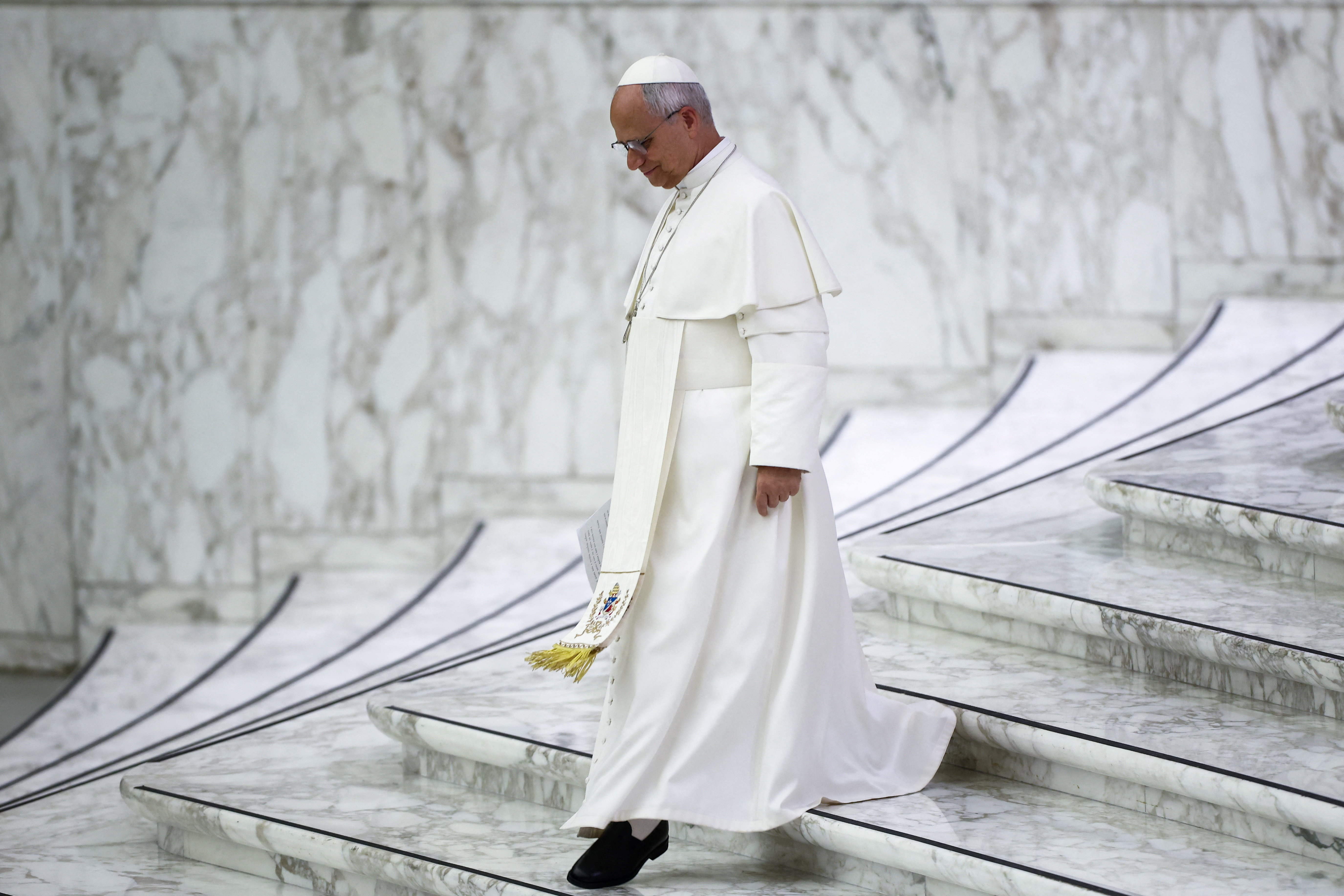 Pope Leo XIV walks after delivering his speech during the swearing-in ceremony of new Swiss Guards in the Paul VI Hall at the Vatican, May 6, 2026. REUTERS/Guglielmo Mangiapane