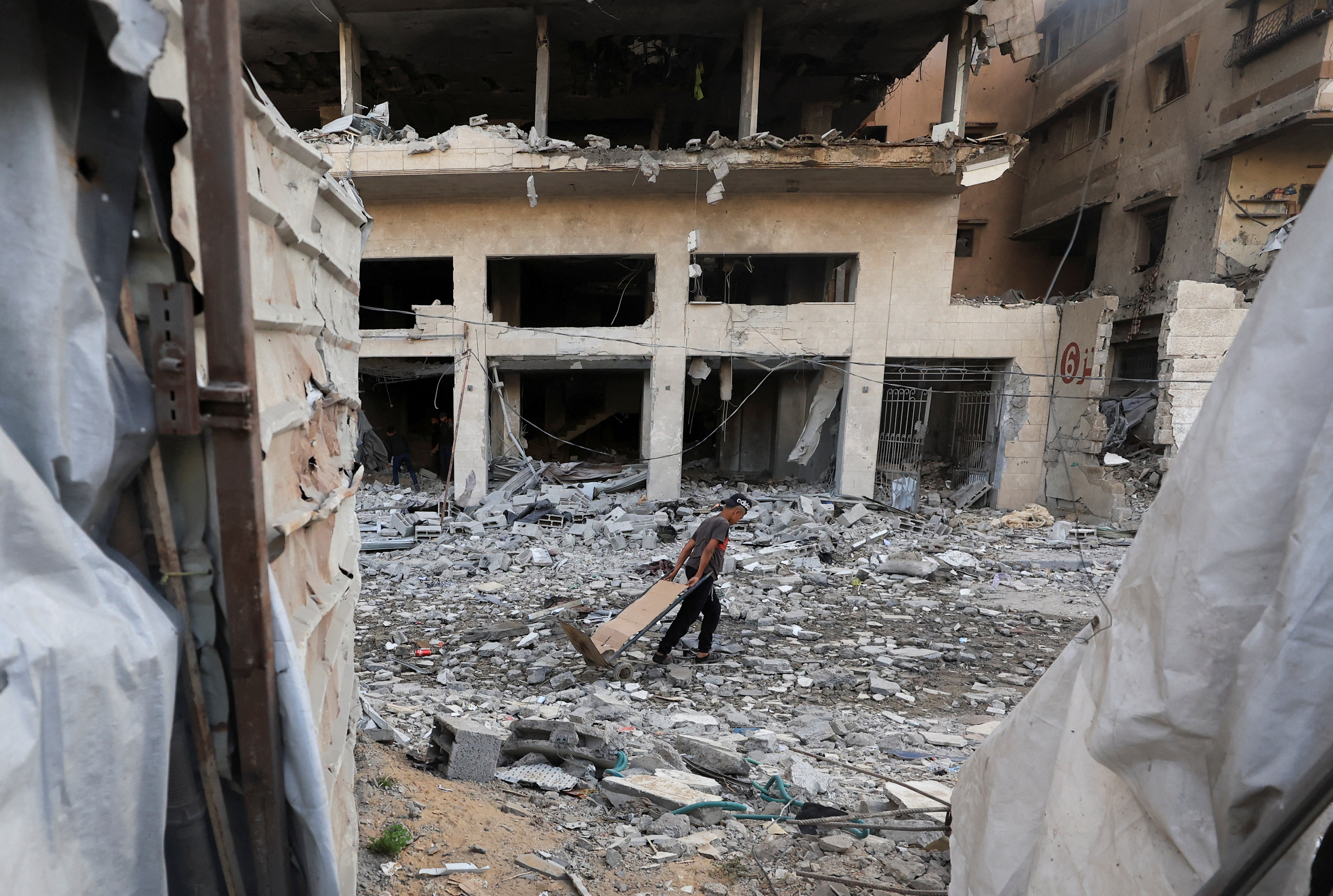 A Palestinian inspects the site of an Israeli airstrike on a residential building on Friday, in Gaza City, May 16, 2026.