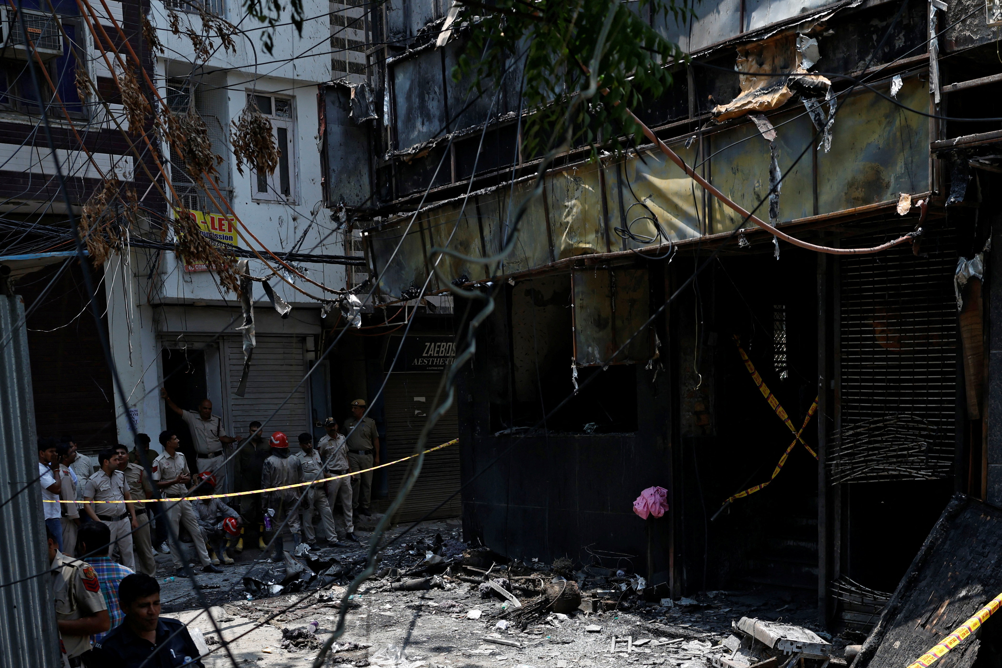 Firefighters and police officers work at the site after a fire at a hotel in New Delhi, India, June 3, 2026. REUTERS/Adnan Abidi