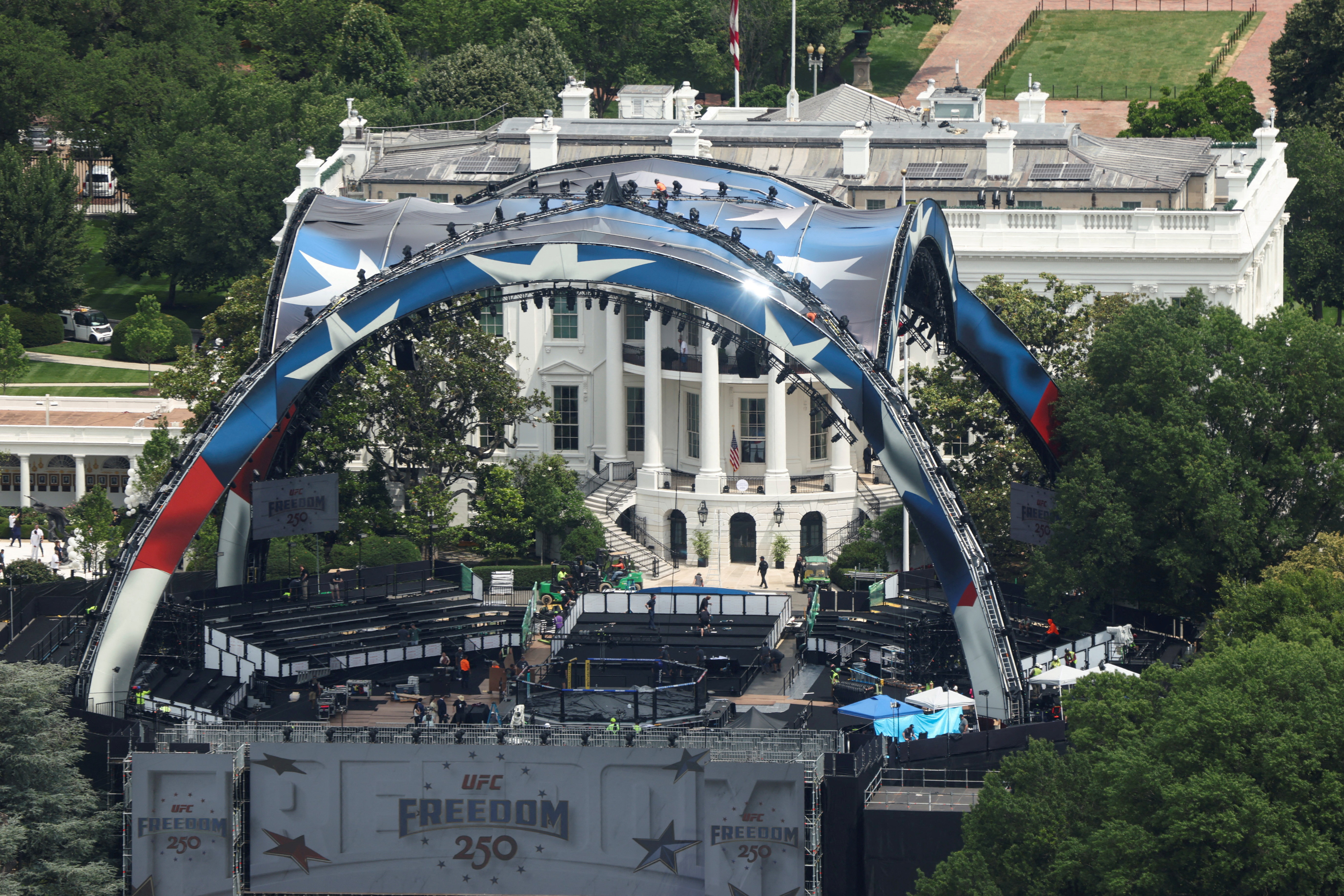 FILE PHOTO: Construction continues on a temporary arena that will host the UFC Freedom 250 fight card at the White House in Washington, D.C., U.S., June 9, 2026. REUTERS/Kevin Lamarque/File Photo