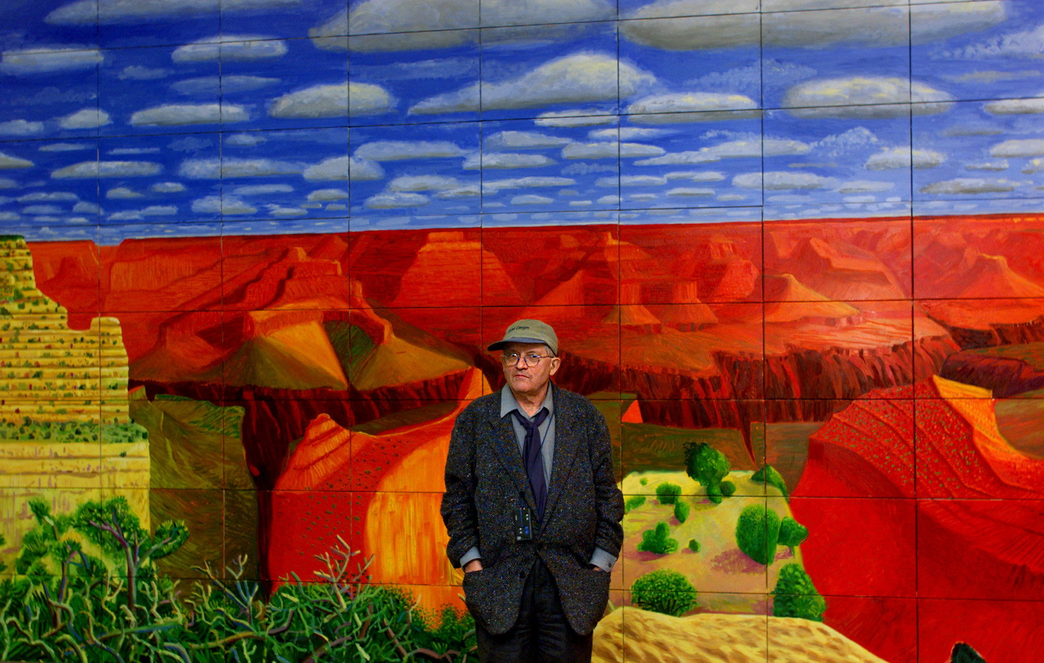 FILE PHOTO: British painter David Hockney, 52, stands in front of one of his paintings "A Closer Grand Canyon, 1998" after a press conference to announce an exhibition of his work at Georges Pompidou Center in Paris