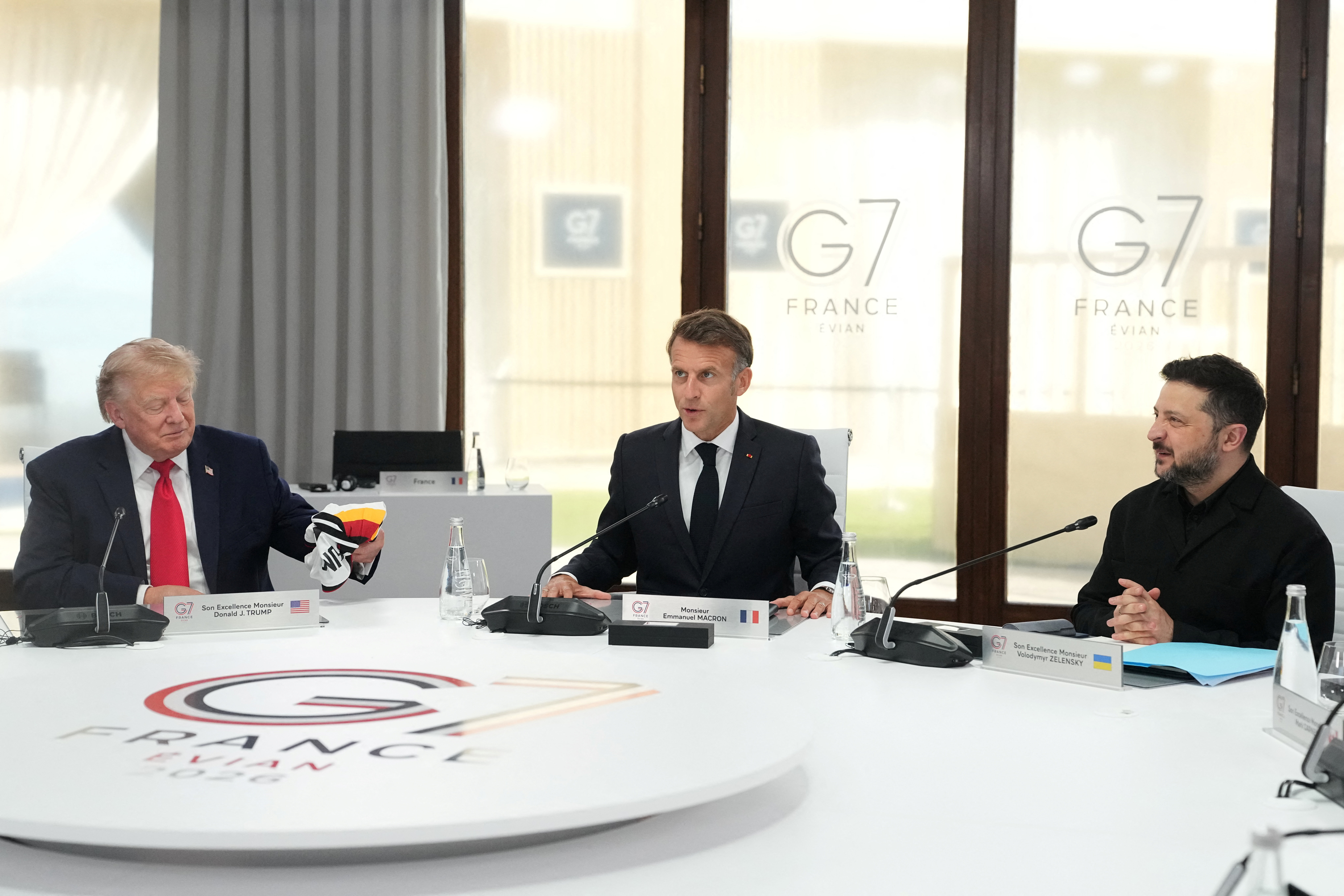 From left, U.S. President Donald Trump, French President Emmanuel Macron and Ukrainian President Volodymyr Zelenskiy during a working session at the G7 summit in Evian-les-Bains, France, June 16, 2026.     Thibault Camus/Pool via REUTERS