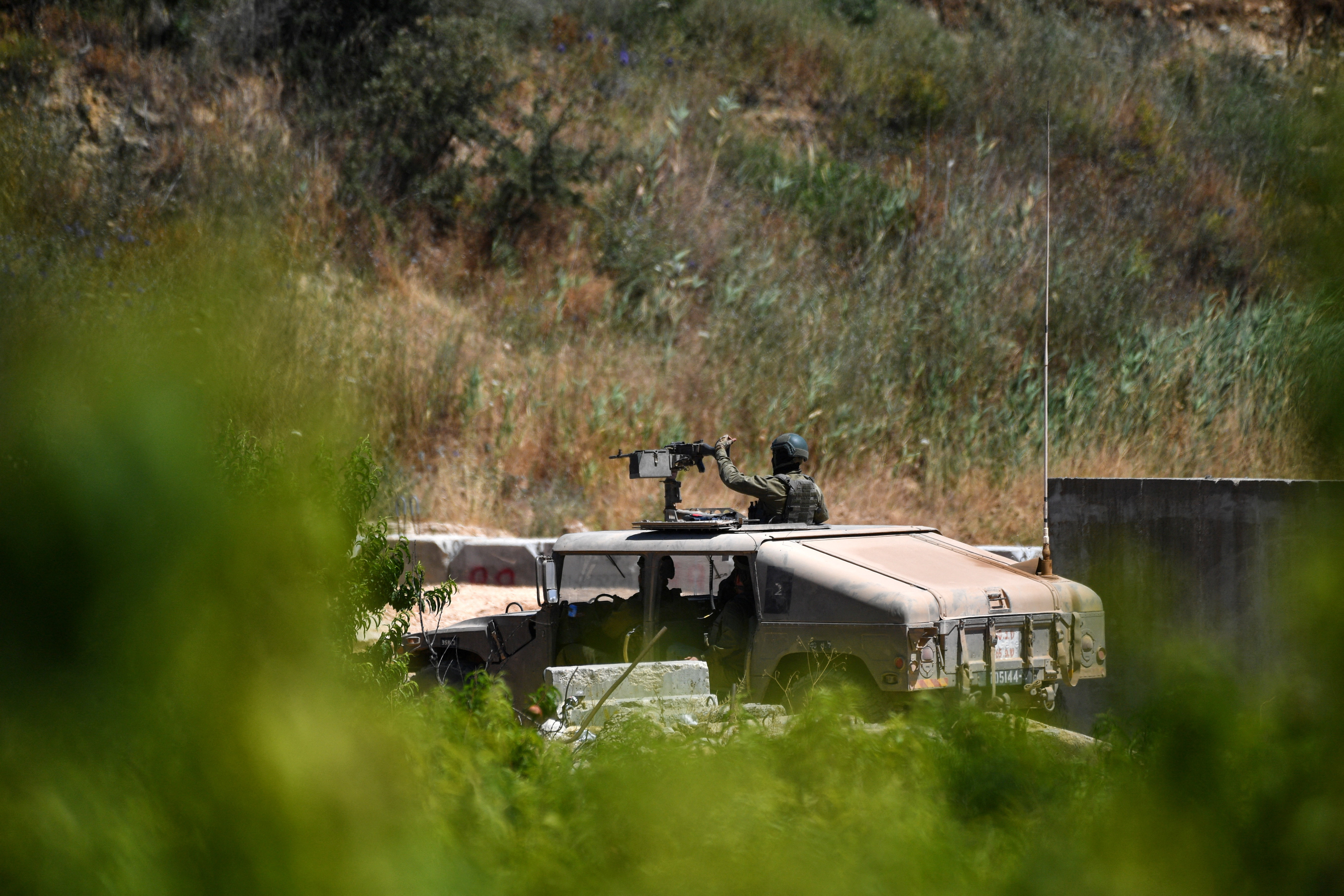 Israeli military vehicles drive on an Israeli road by the Israel-Lebanon border, in northern Israel, June 18, 2026