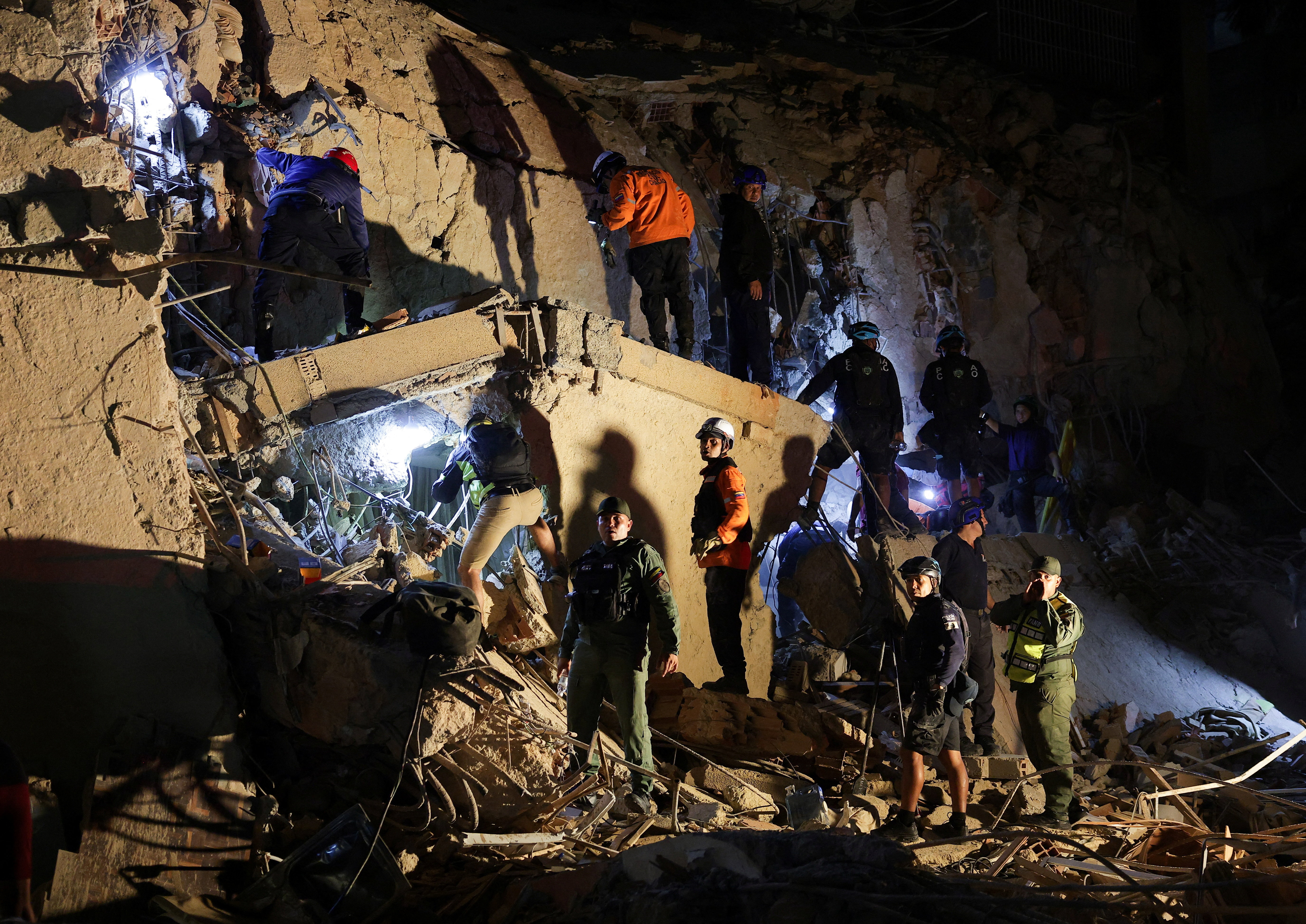 Emergency services work at the site of a collapsed building after earthquakes hit the country, in Caracas, Venezuela, June 24, 2026. REUTERS/Gaby Oraa
