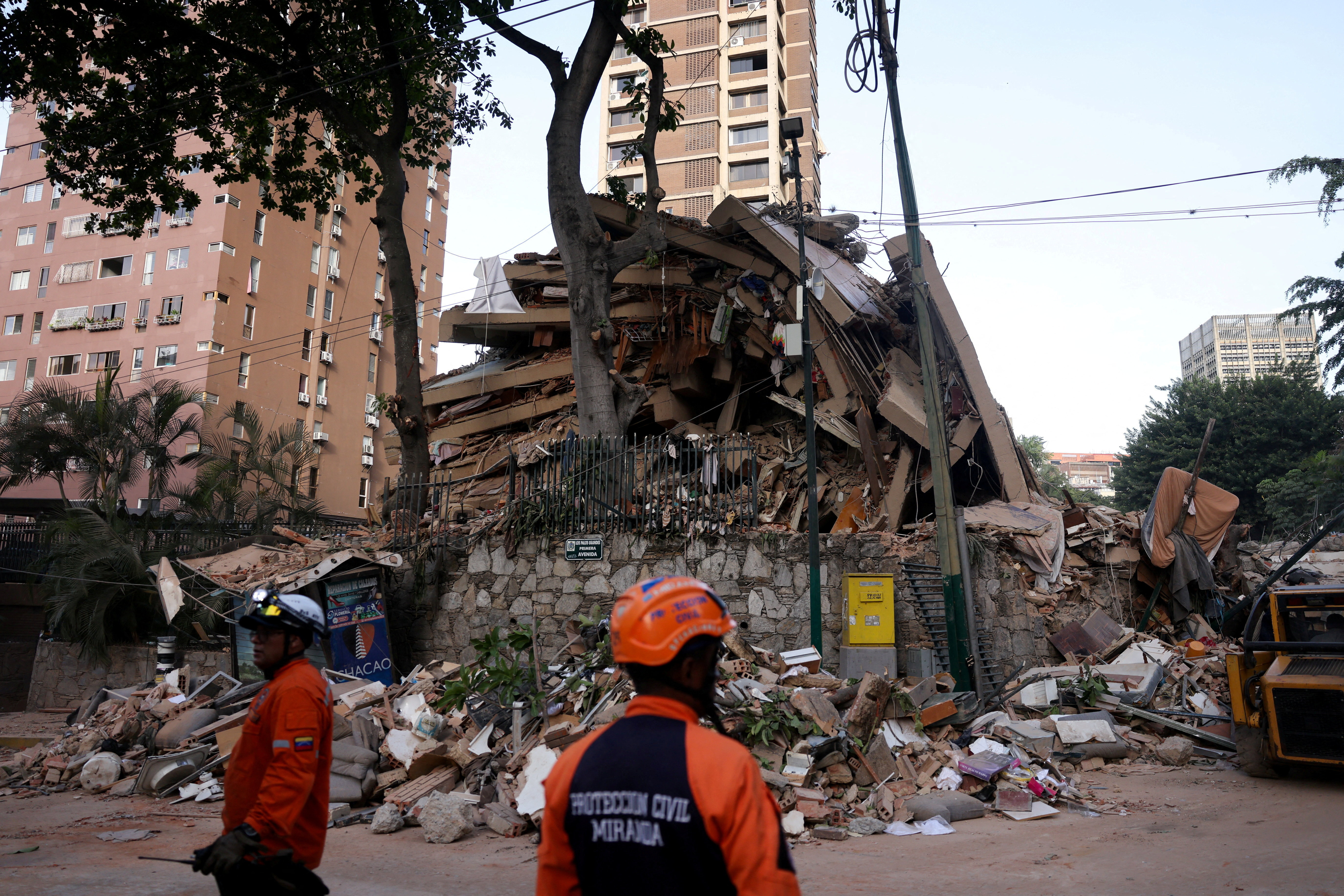 Emergency services work at the site of a collapsed building after earthquakes hit the country, in Caracas, Venezuela, June 25, 2026.