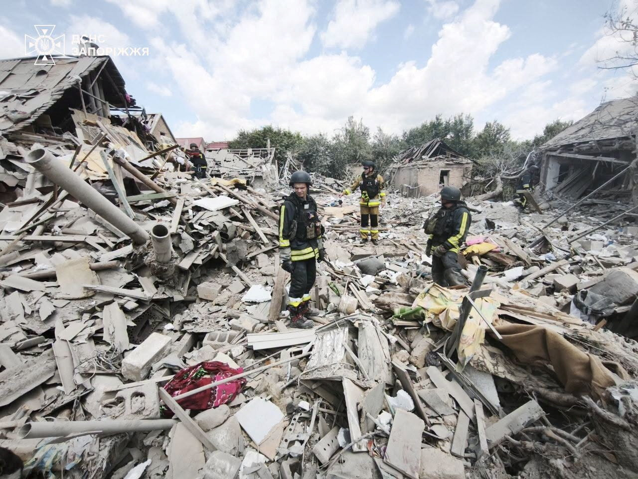 Rescuers work at a site of a Russian air strike. Press service of the State Emergency Service of Ukraine in Zaporizhzhia region/Handout via REUTERS