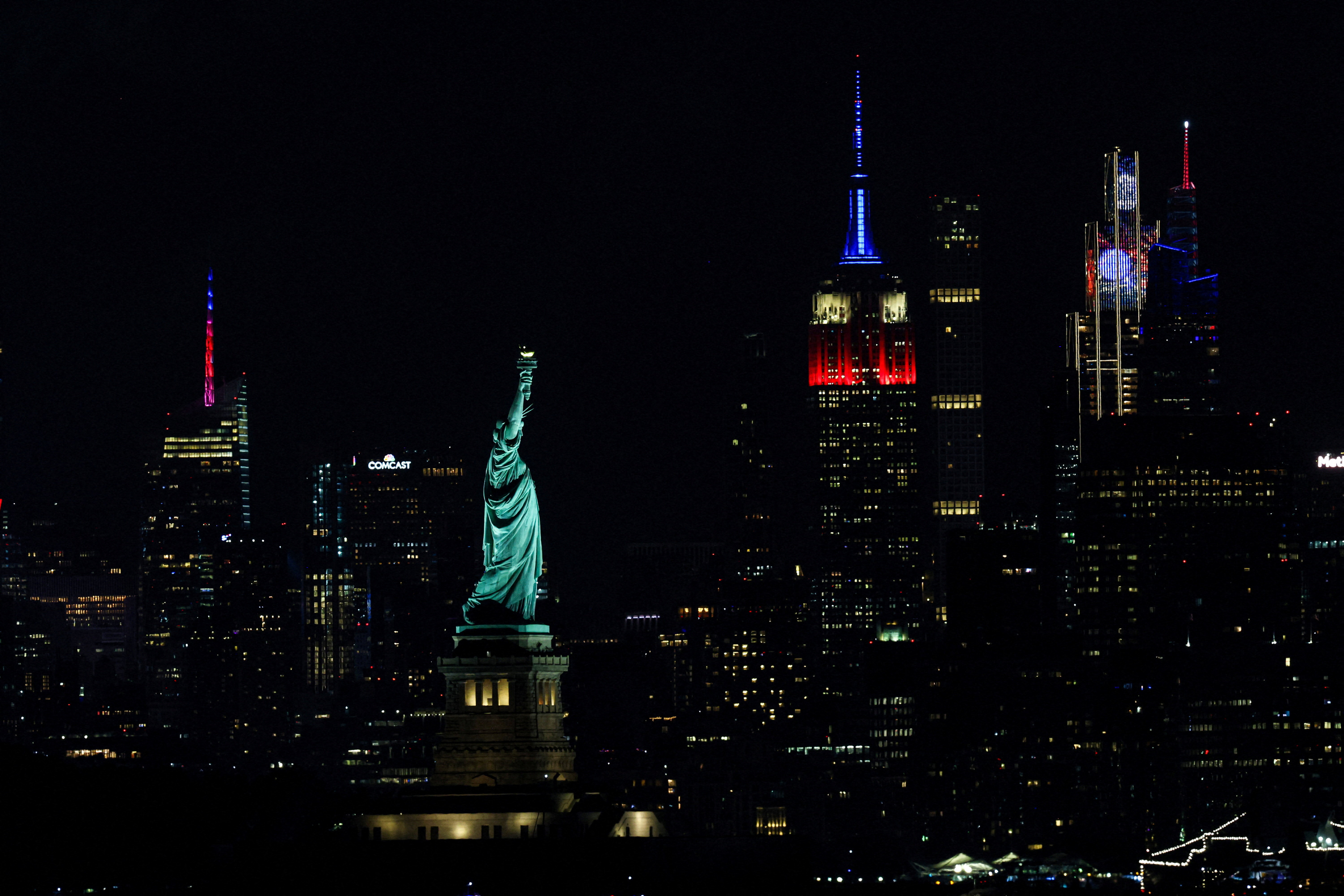 The Statue of Liberty and The Empire State Building are illuminated as the United States celebrates its 250th anniversary on Independence Day in New York City, U.S., July 4, 2026. EUTERS/Brendan McDermid