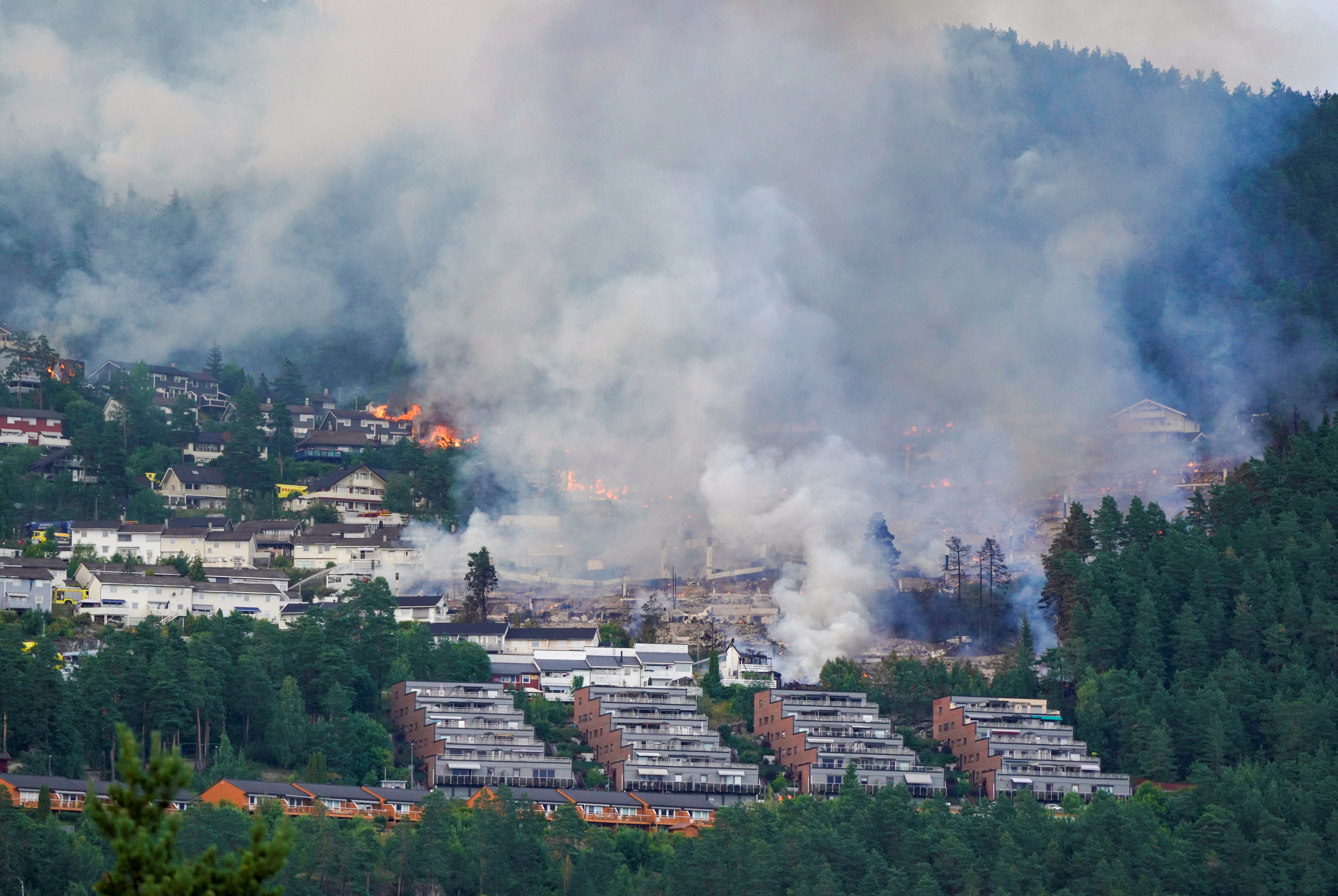 Smoke rises from a large fire that has spread from terraced houses in Krokstadelva. Thomas Fure/NTB/via REUTERS