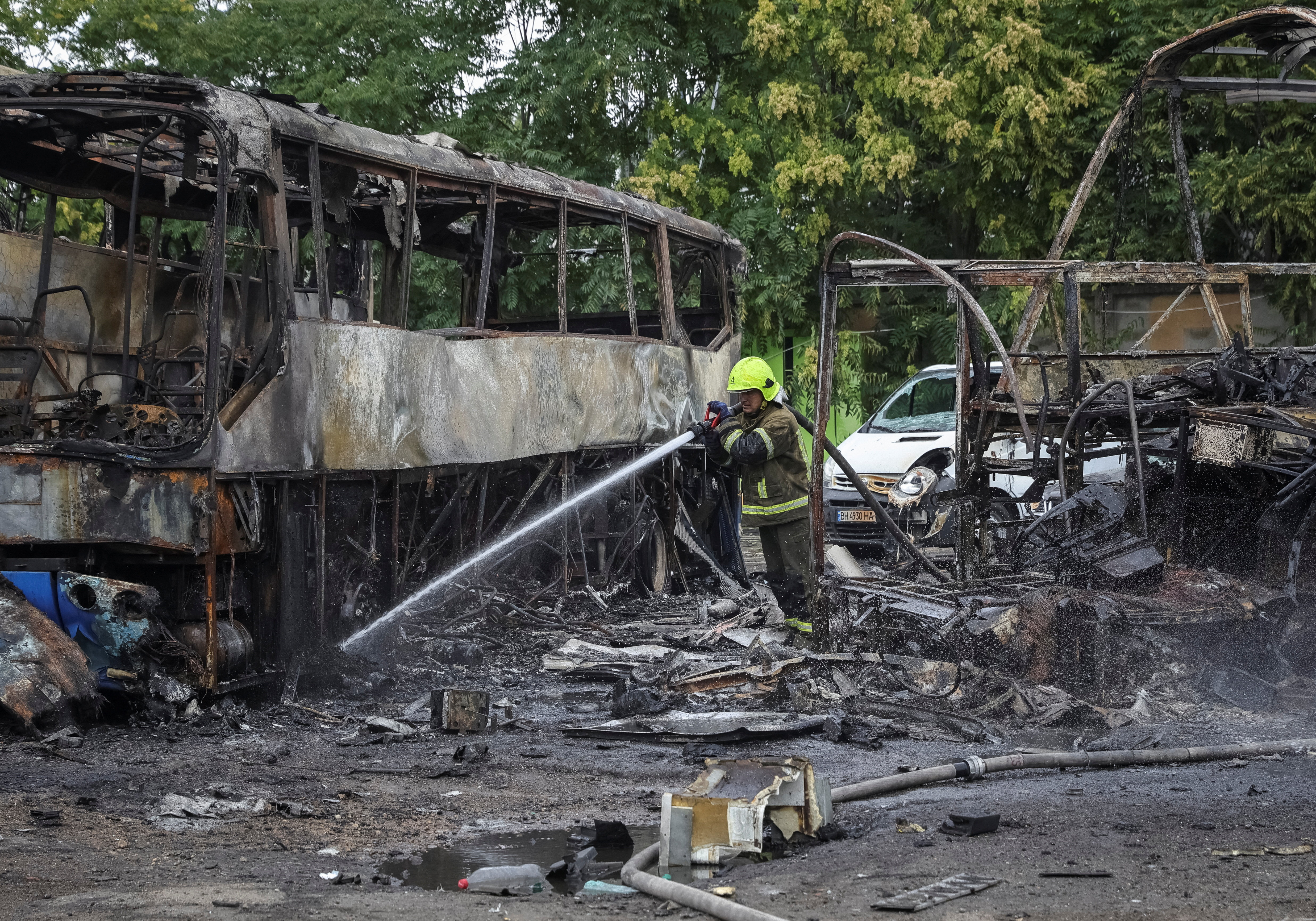 A firefighter works at the site of a bus parking hit by a Russian drone strike, amid Russia's attack on Ukraine, in Odesa, Ukraine, July 13, 2026.
