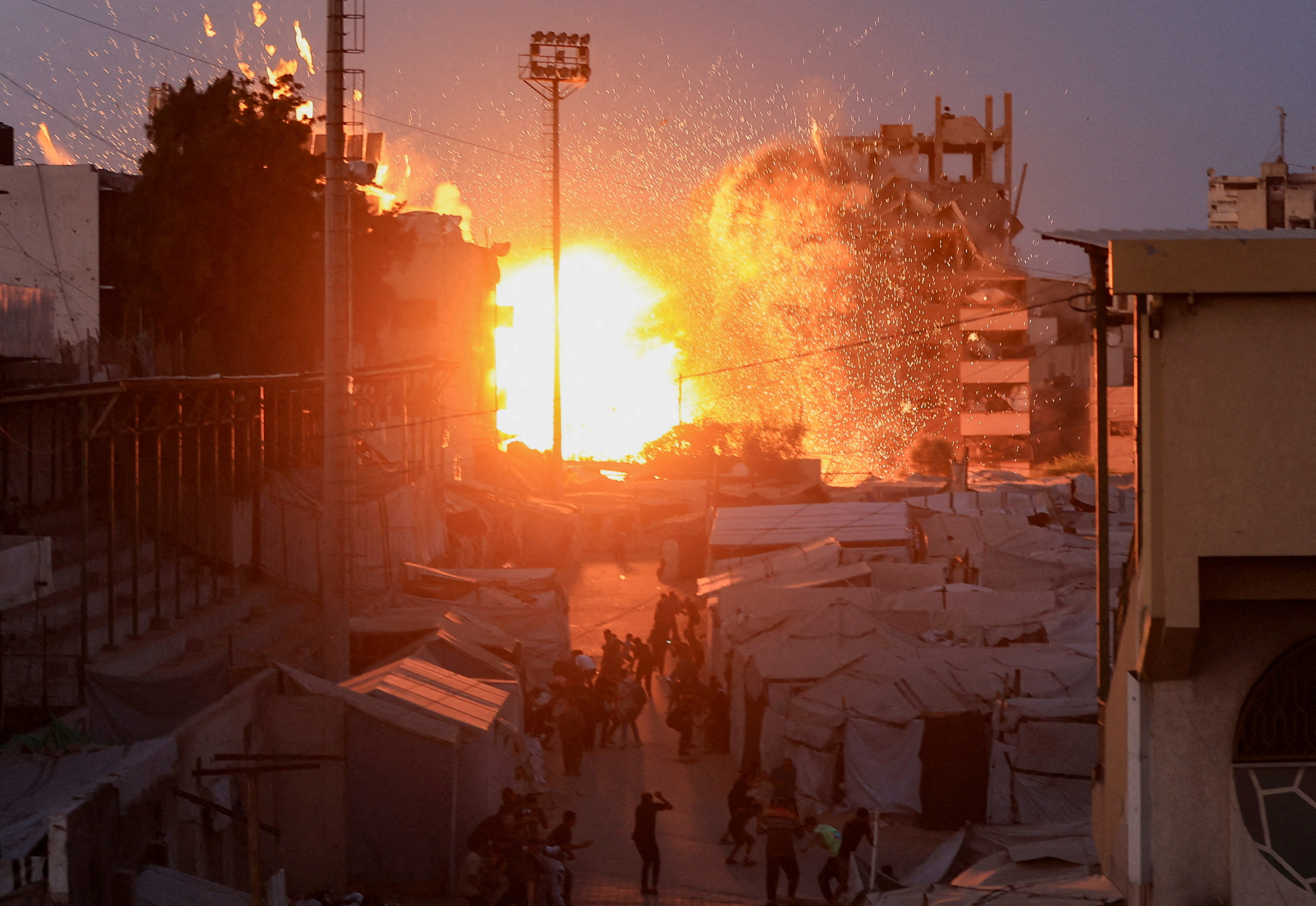 Smoke and flames rise after an Israeli airstrike hit a mosque in Gaza City, July 28, 2026.