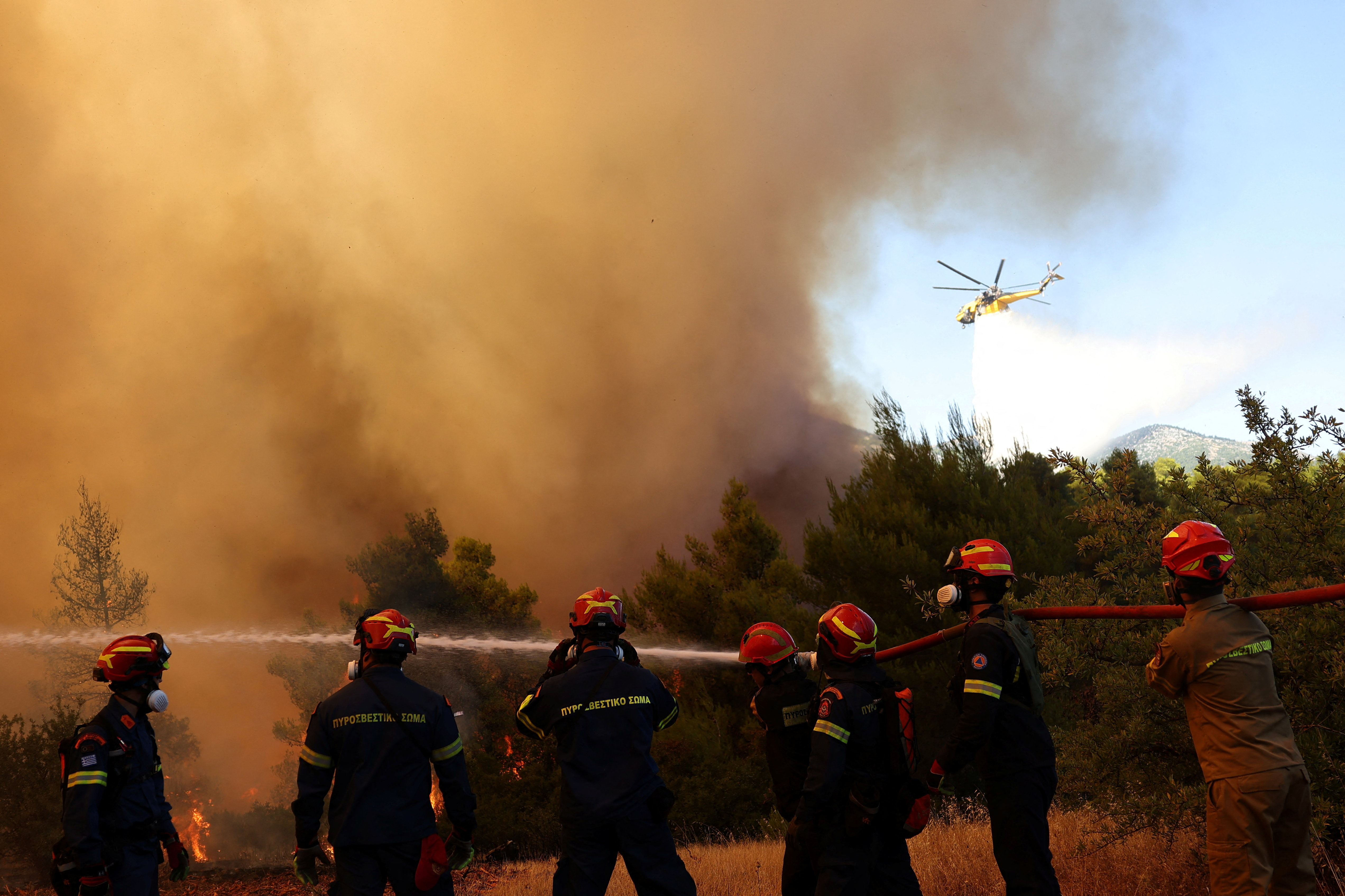 Firefighters battle a wildfire near the village Agia Paraskevi, Greece, August 2, 2026. REUTERS/Stelios Misinas