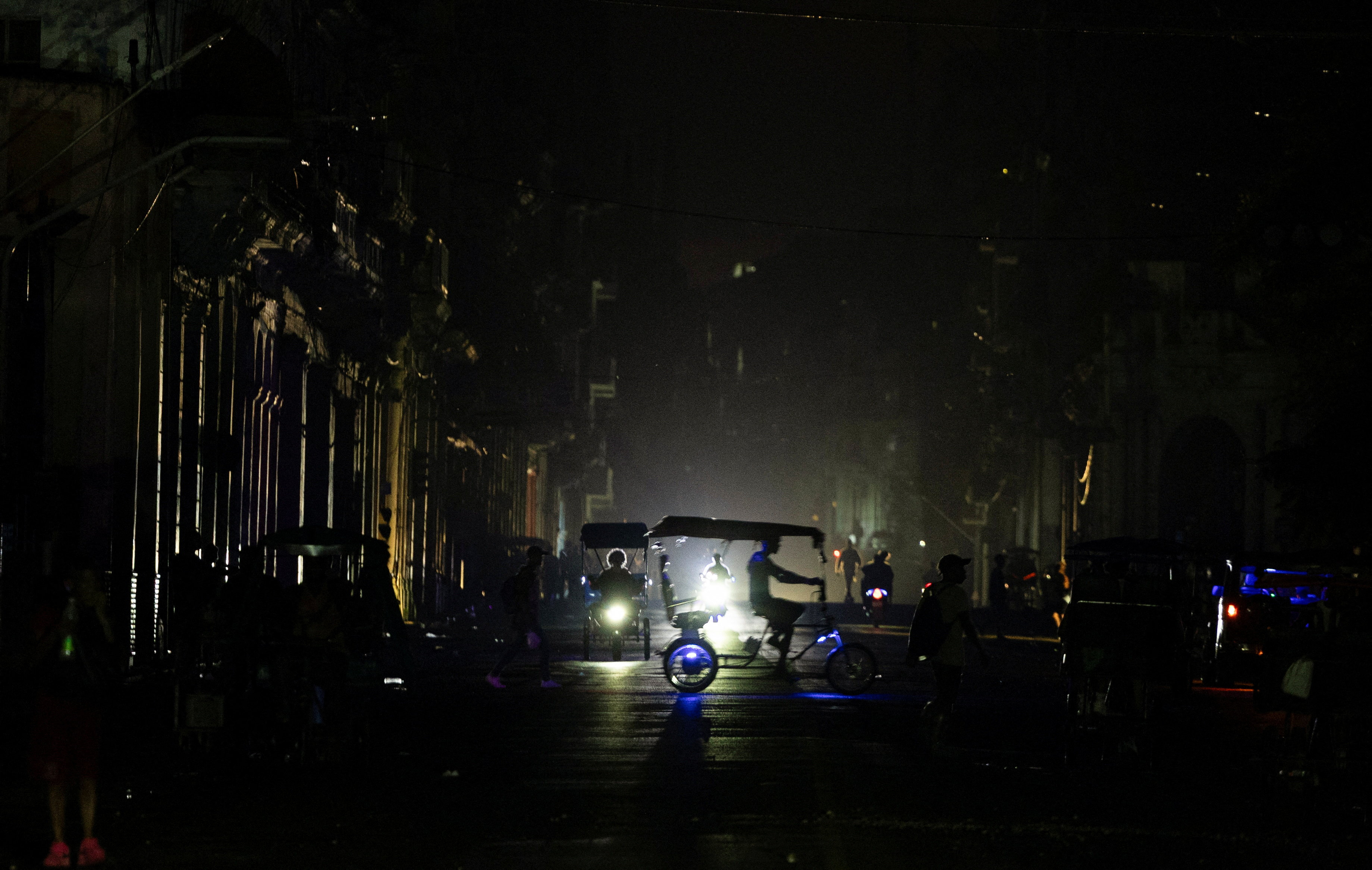A bicitaxi driver rides across a street as Cuba's national electrical grid collapsed again on Monday while the government was trying to restore power following a nationwide blackout on Sunday, in Havana, Cuba August 3, 2026. REUTERS/Norlys Perez