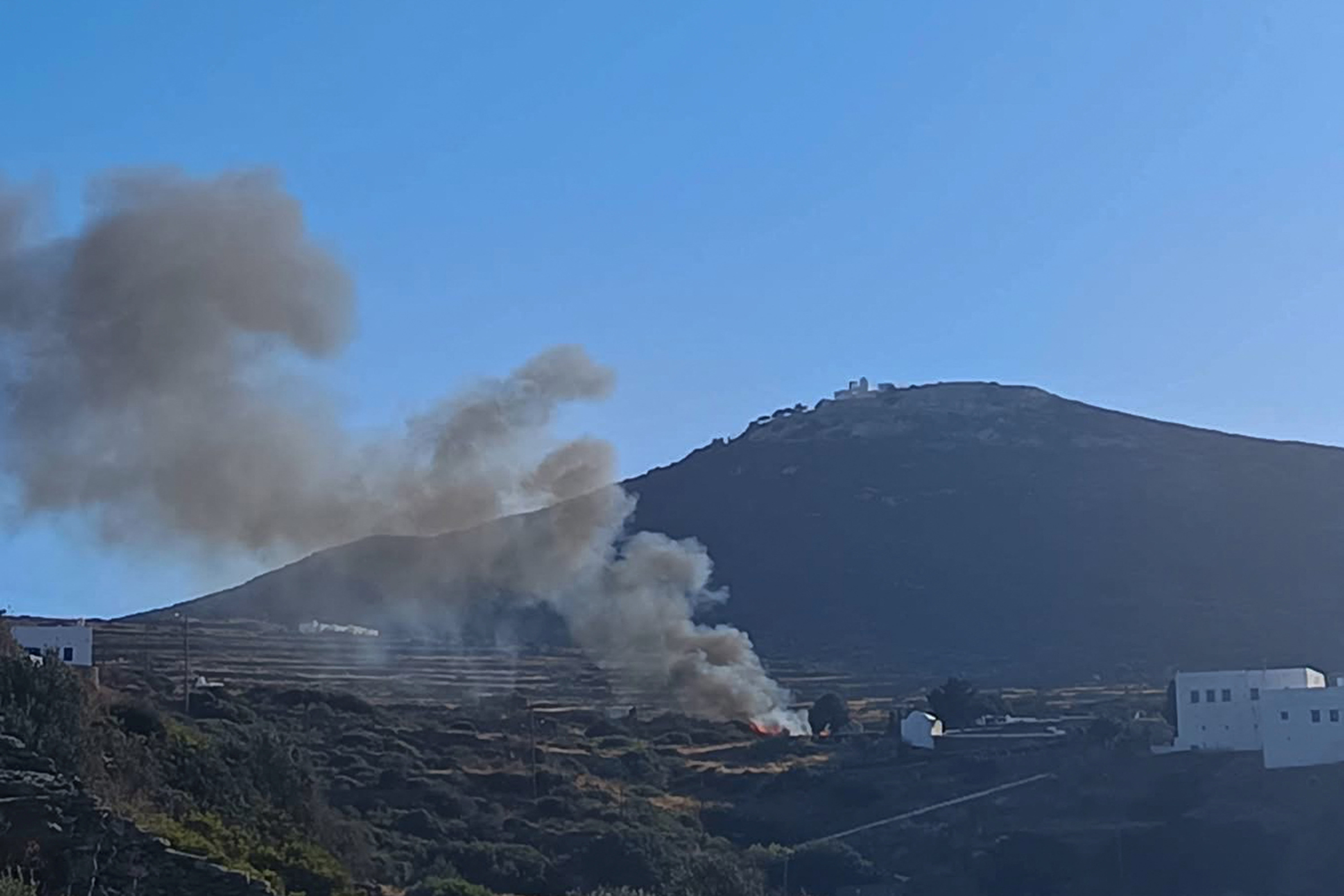 Smoke billows from the site of a helicopter crash. Handout via REUTERS.