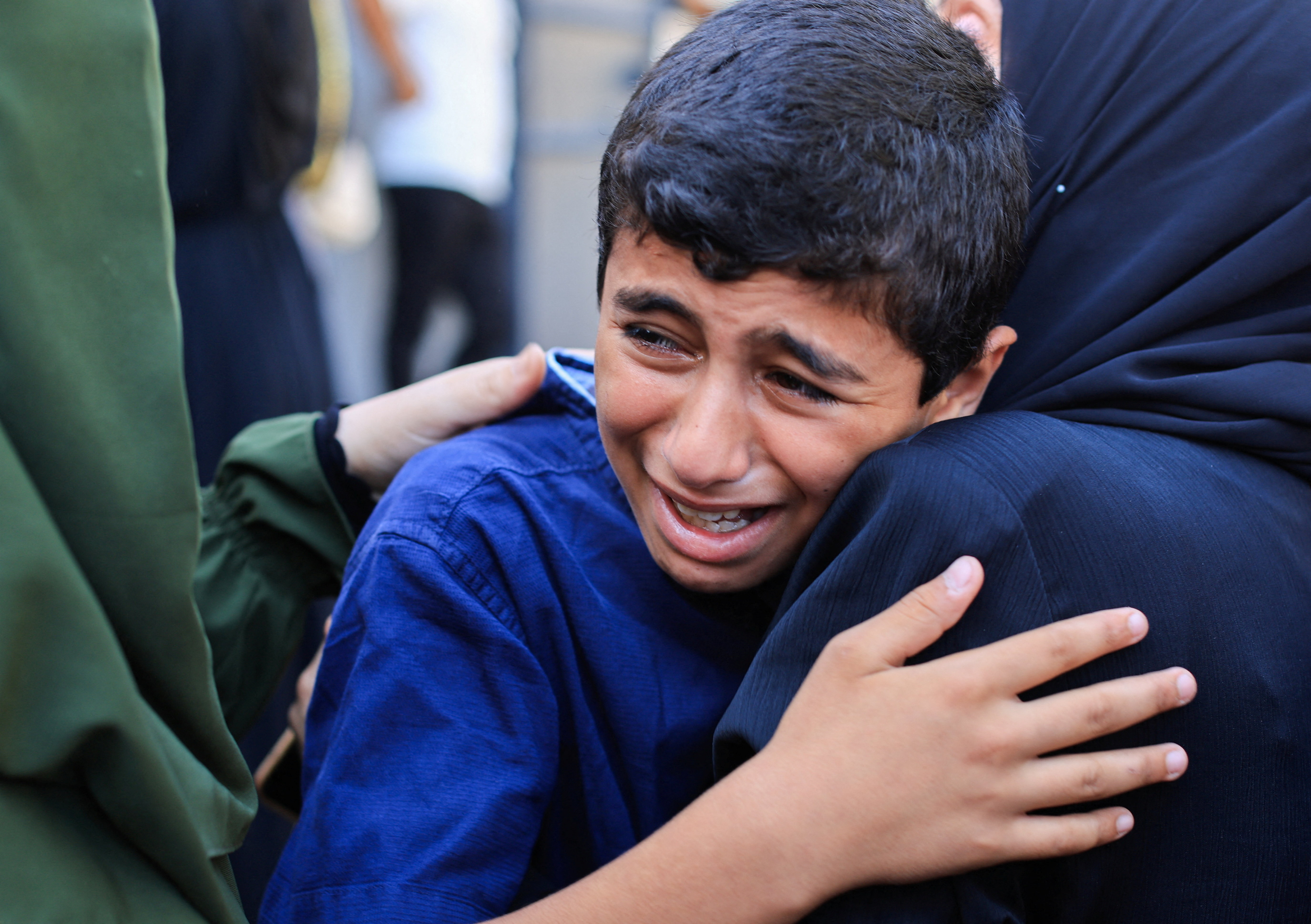 A boy mourns during the funeral of Palestinians who were killed in Israeli strikes, according to medics, in Gaza City