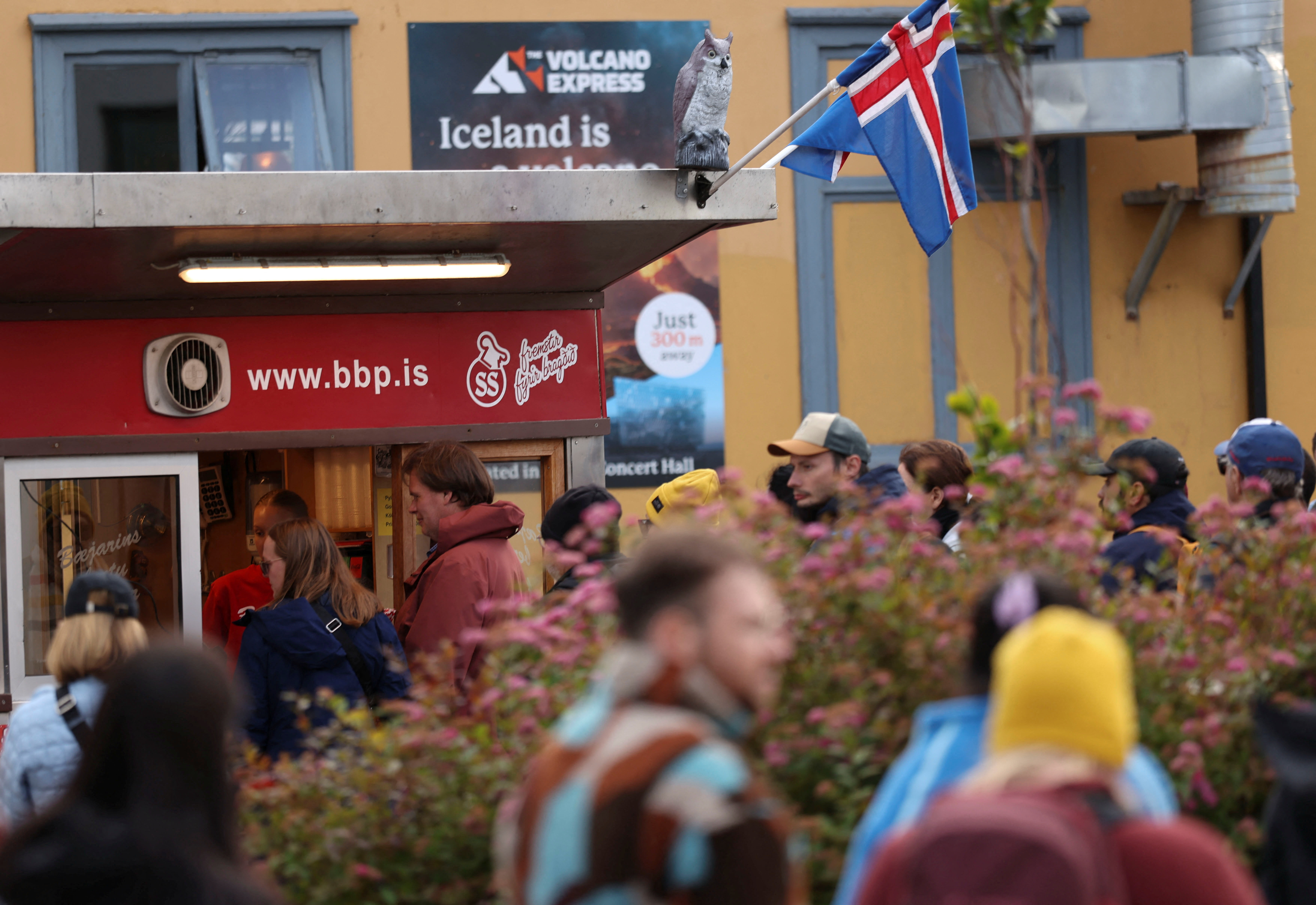 Tourists queue for a hot dog from Baejarins Beztu Pylsur stand ahead of a referendum on whether Iceland should resume accession negotiations with the European Union, in Reykjavik