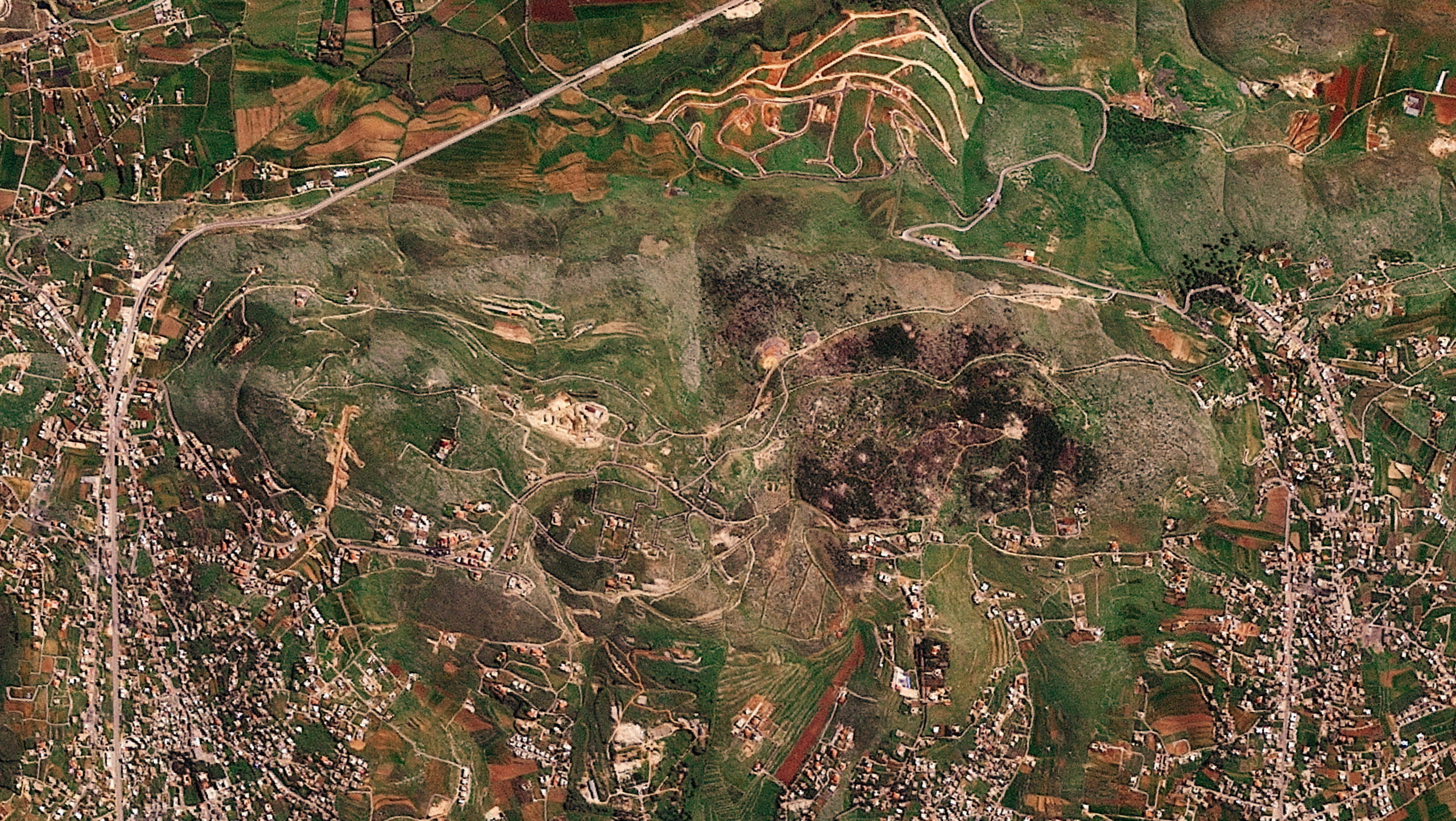 A satellite image shows damage at the Ali al-Taher ridge near Nabatiah, Lebanon, March 8, 2026. 2026
