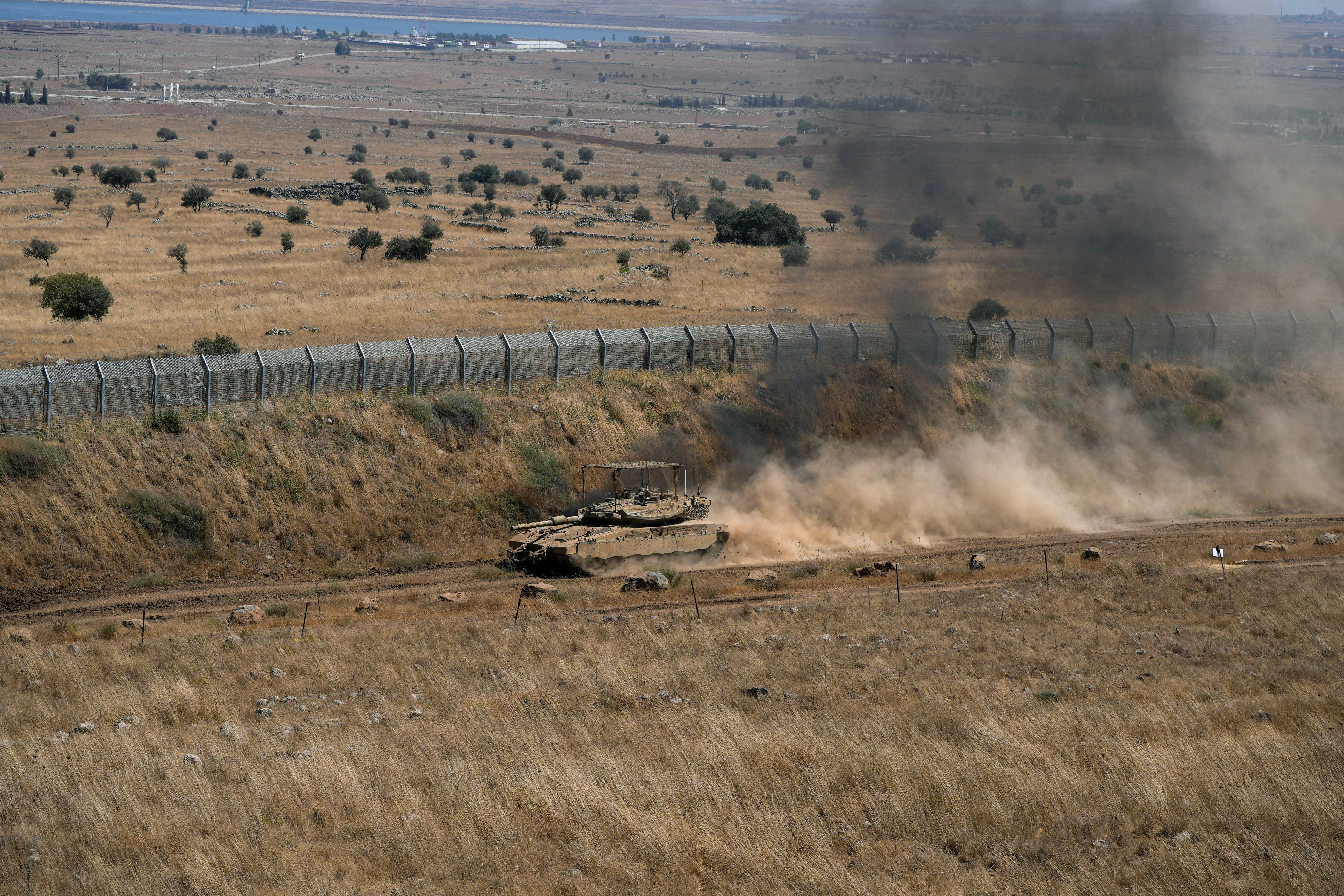 An Israeli tank drives along the ceasefire line between the Israeli-occupied Golan Heights and Syria, on its Israeli side August 20, 2026.