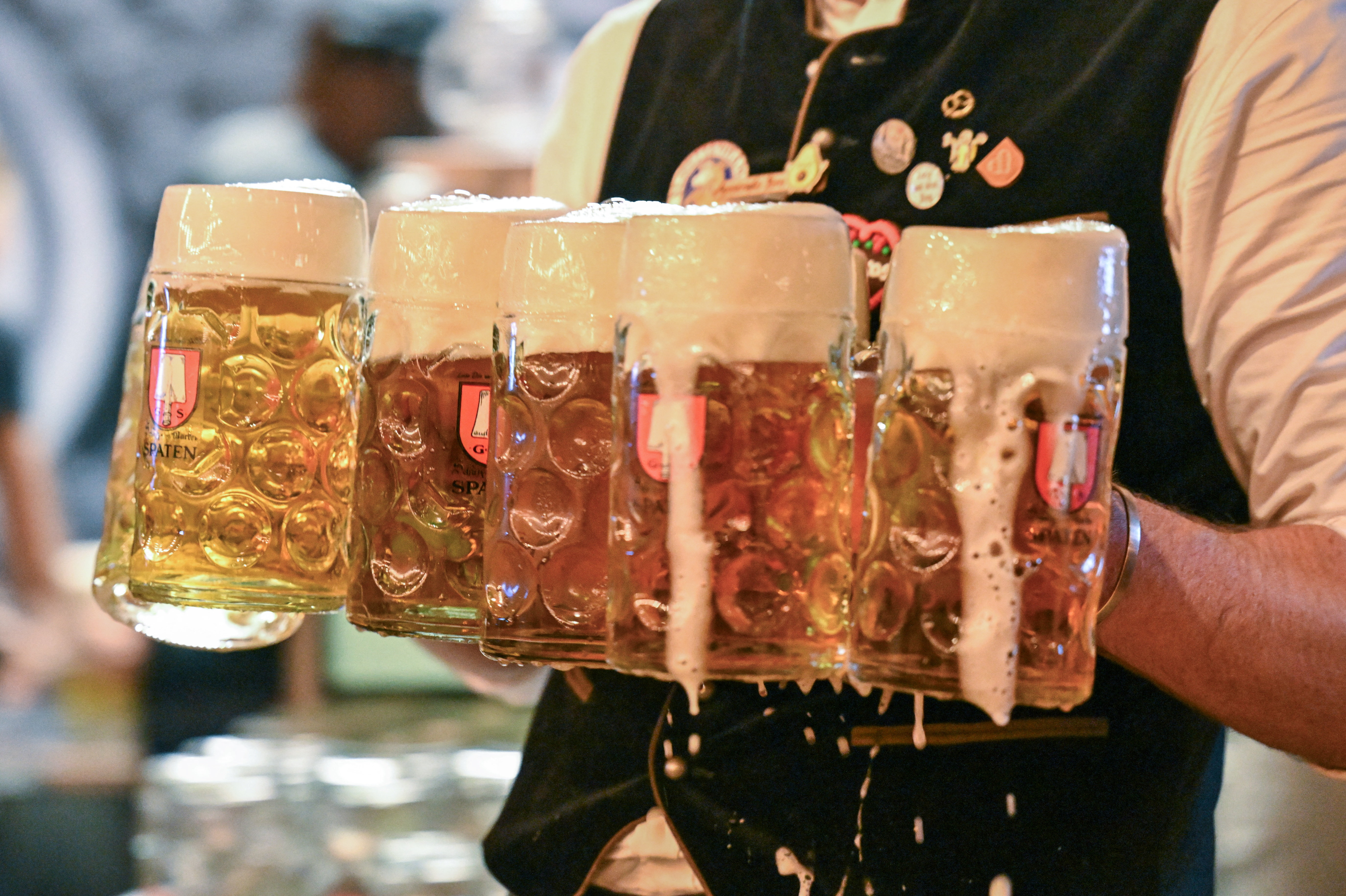 A man carries beer steins during the official opening day of the 191st Oktoberfest, the world's largest beer festival, in Munich, Germany, September 19, 2026. REUTERS/Fariha Farooqui