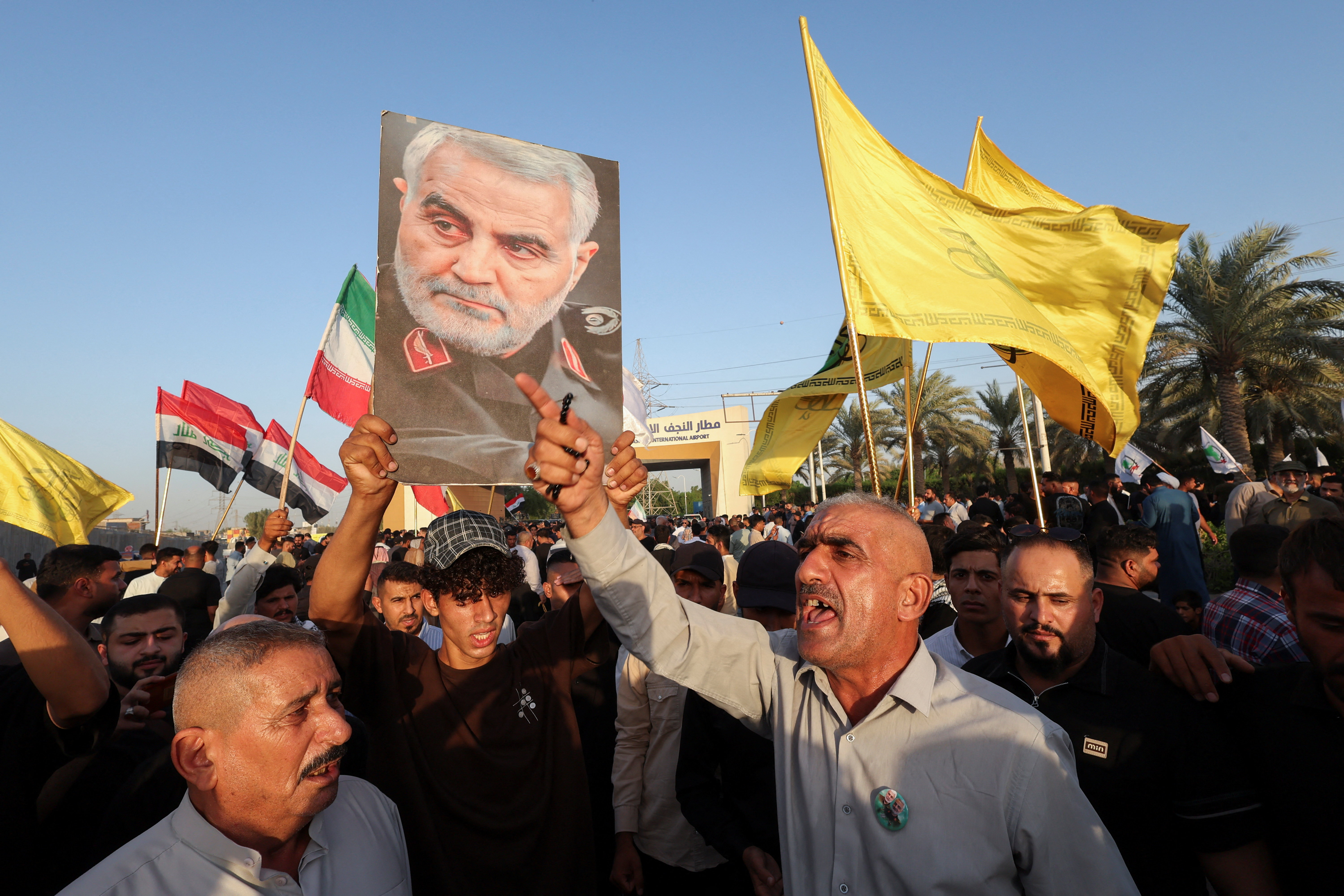 A protester holds a portrait of slain Iranian military commander Qassem Soleimani during a protest against U.S. restrictions targeting Iranian aviation activities and their impact on flights between Iran and Iraq