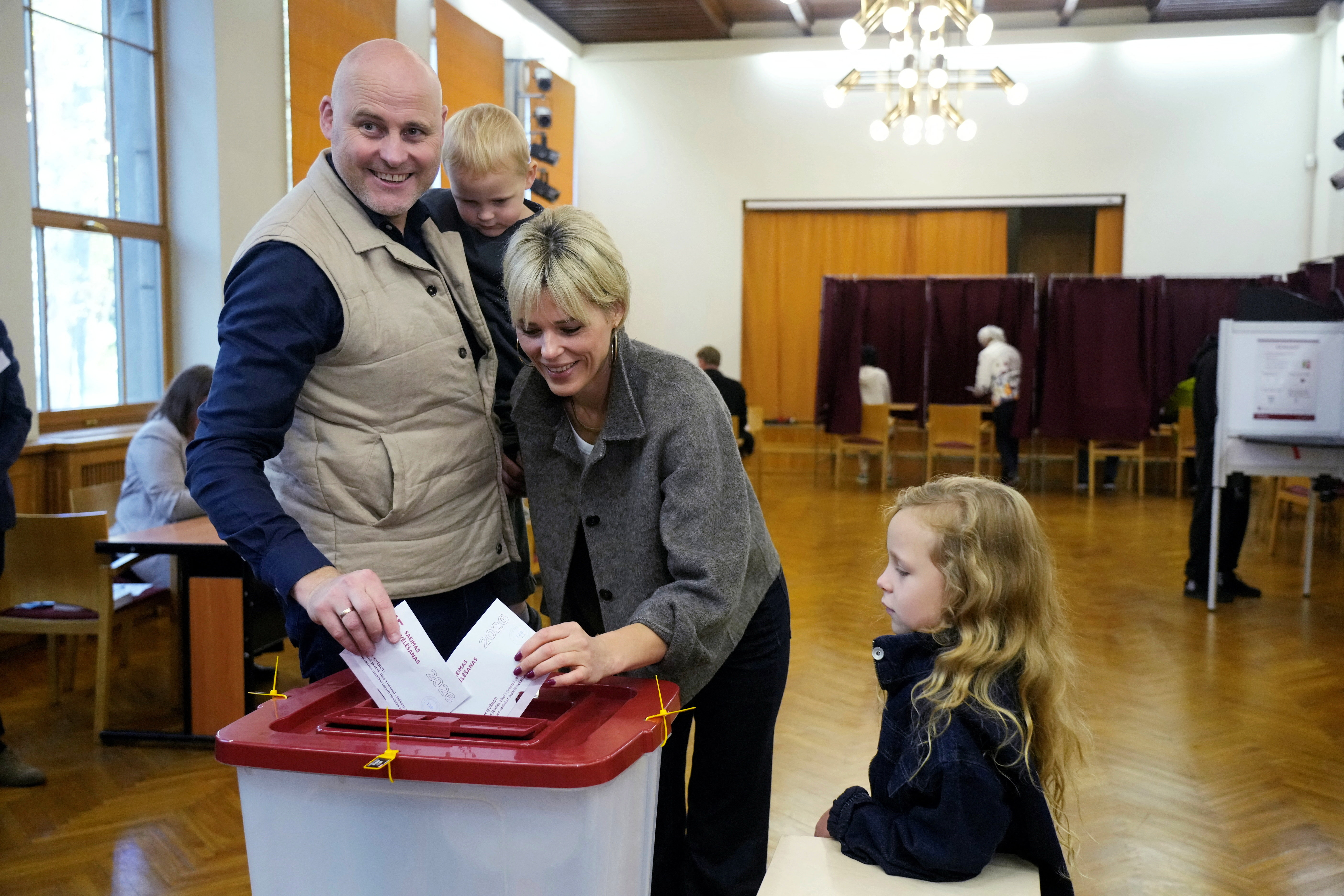 Latvian Prime Minister Andris Kulbergs and his wife Anna cast their votes during the general election in Riga, Latvia, October 3, 2026.