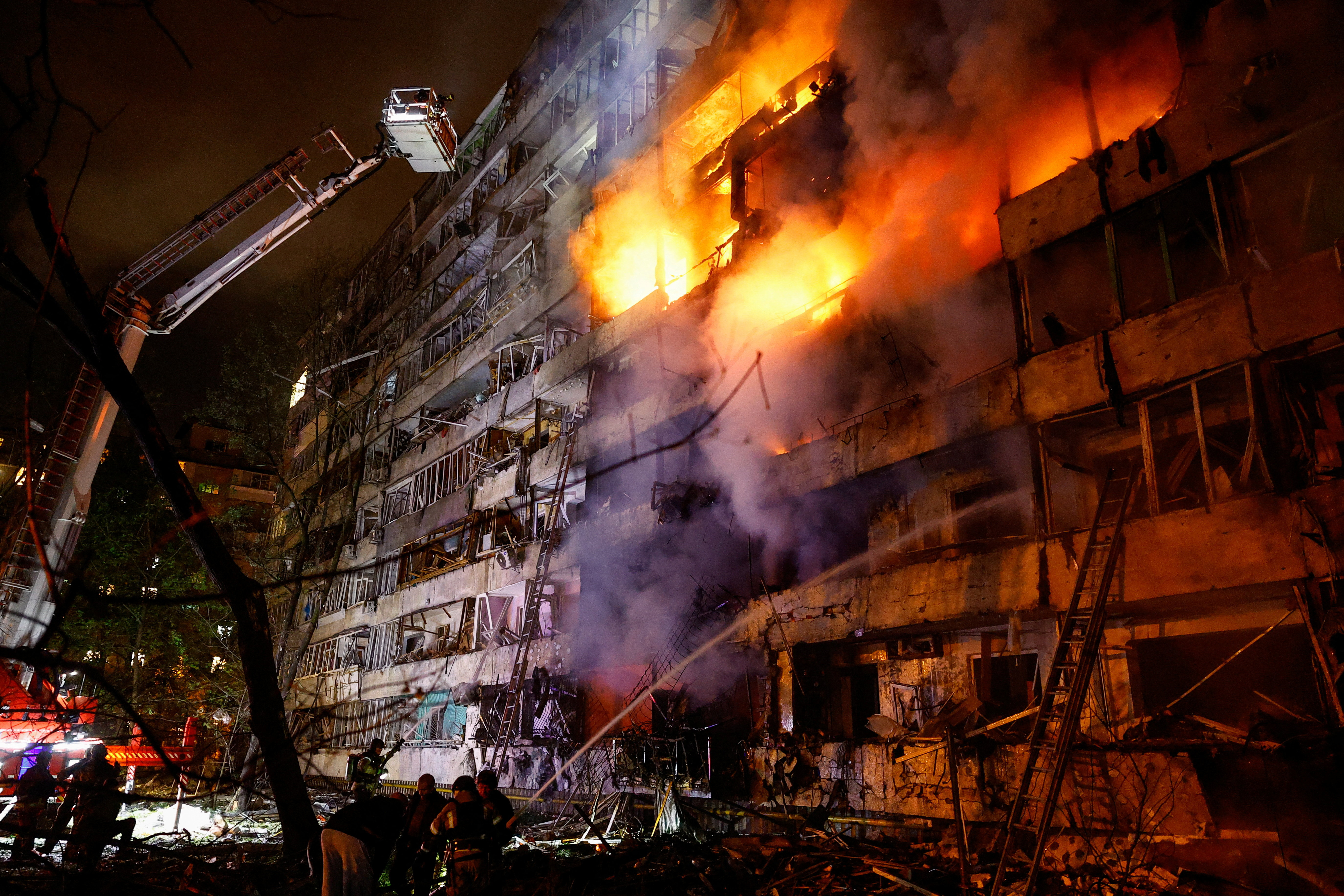 Firefighters work at the site of an apartment building damaged by a Russian missile strike, amid Russia's attack on Ukraine, in Kyiv, Ukraine October 14, 2026. REUTERS/Valentyn Ogirenko