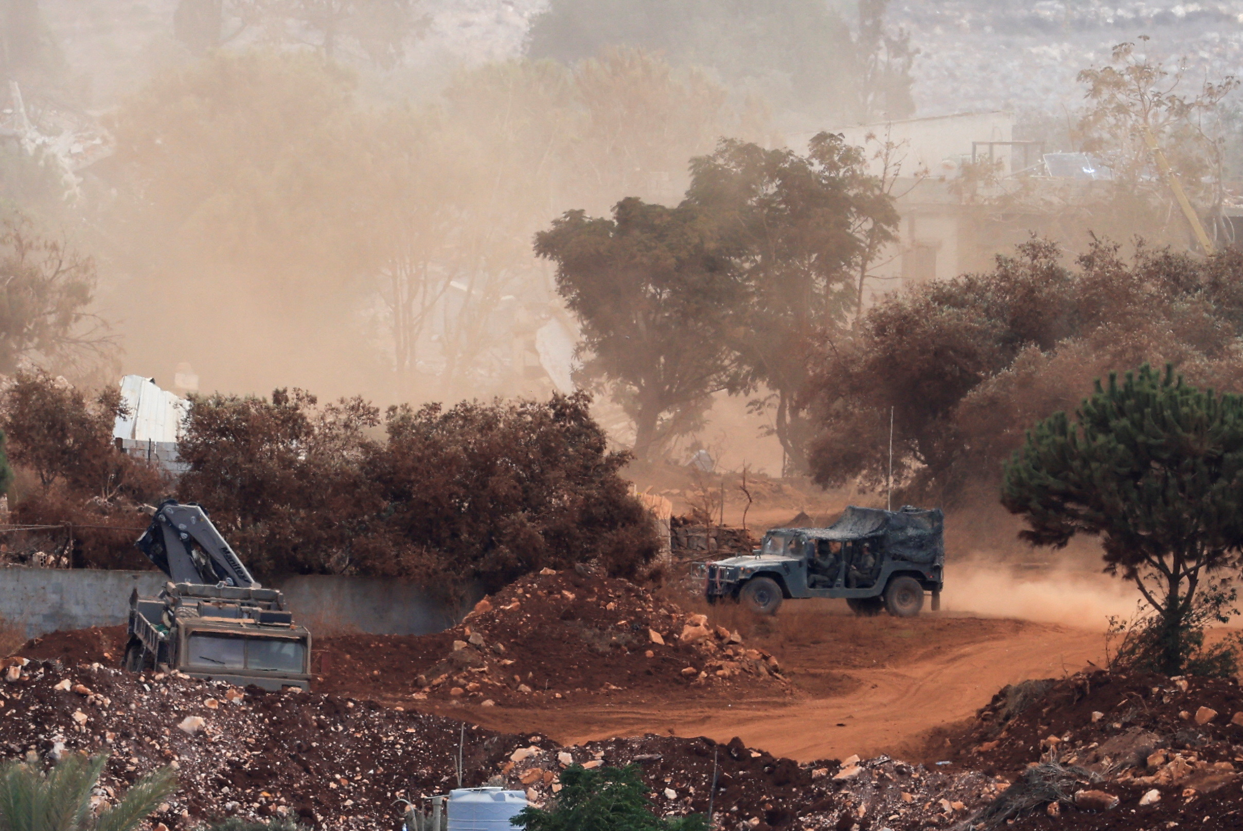 An Israeli army vehicle operates in East Zawtar, as seen from West Zawtar, southern Lebanon, October 1, 2026.