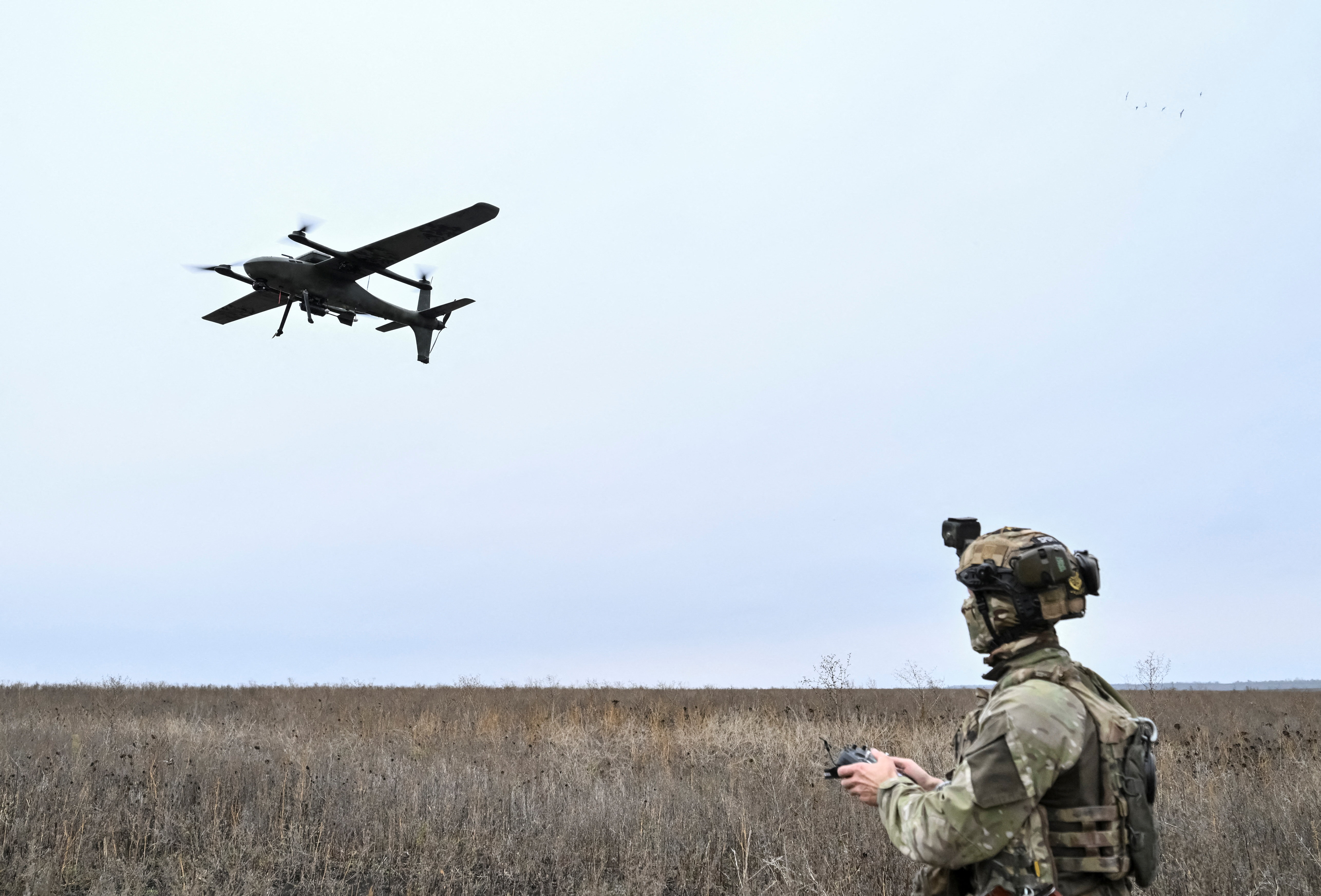 A serviceman of the National Police Special Purpose Battalion Zaporizhzhia region controls a Gara reconnaissance and strike drone while they work at a position near a front line, amid Russia's attack on Ukraine