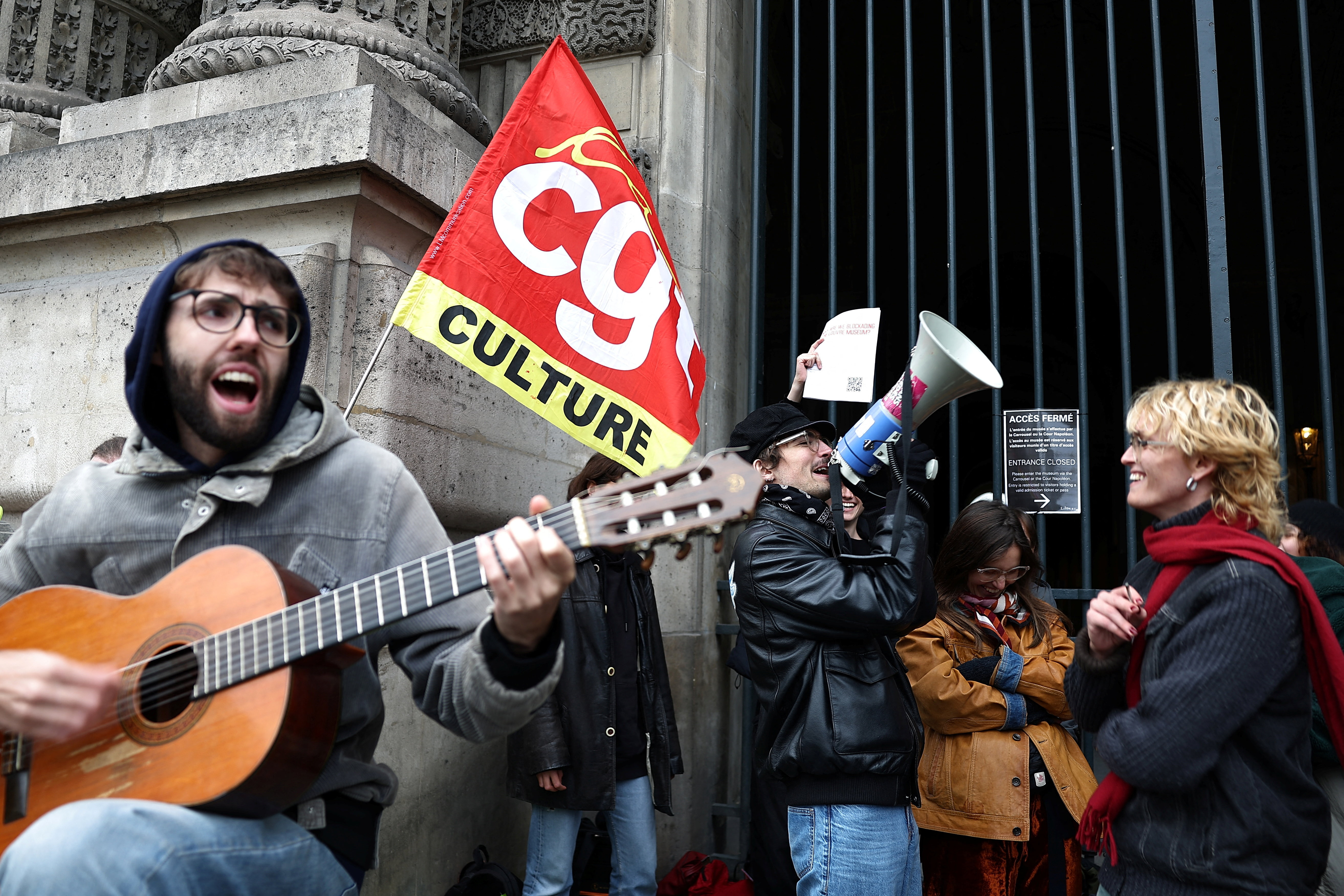 Protesters and students from art and culture schools gather in front of a closed entrance of the Louvre Museum during a demonstration in support of a high school student movement demanding better school conditions and government action